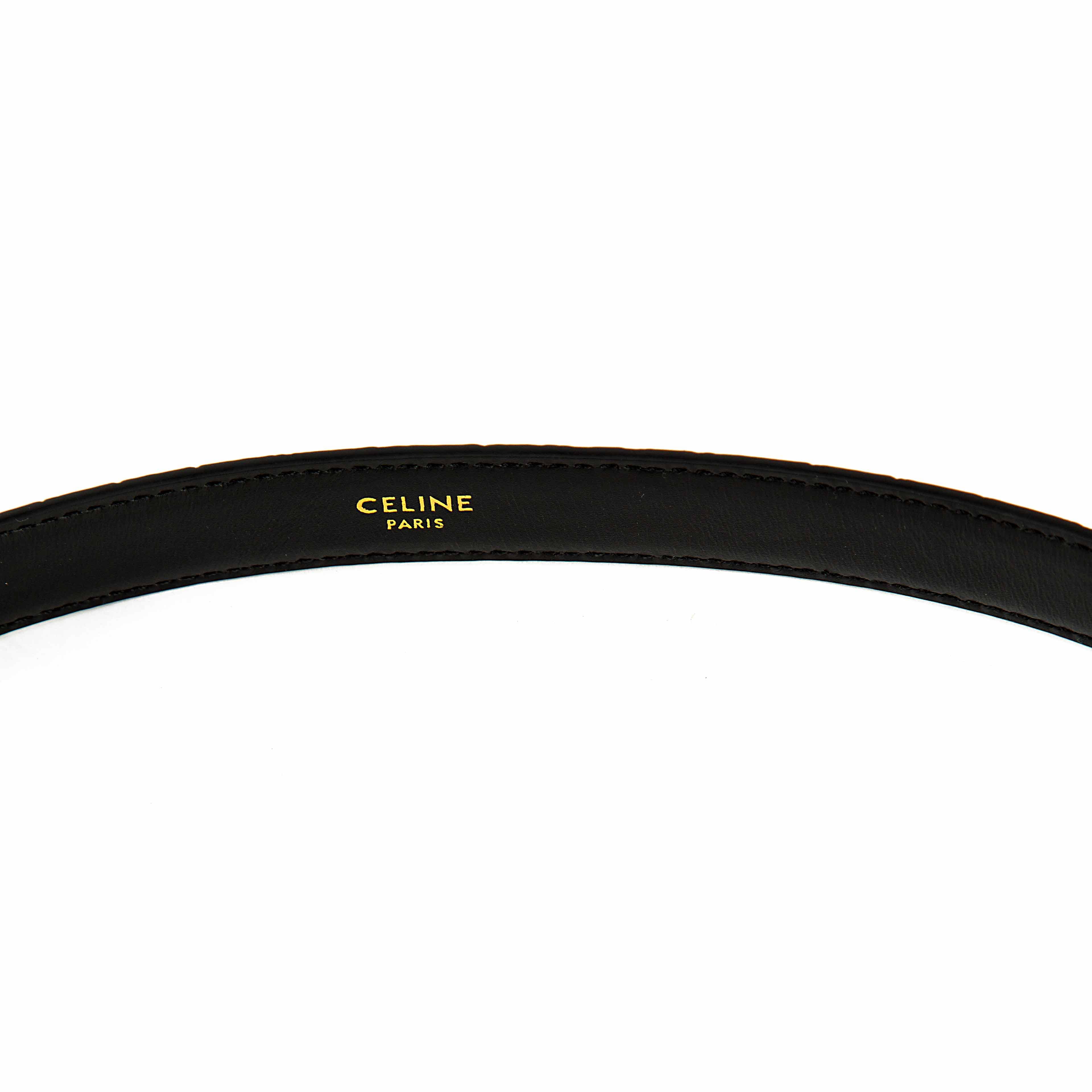 This elegant accessory is a masterclass in understated luxury, featuring a smooth, semi-matte black calfskin leather strap.