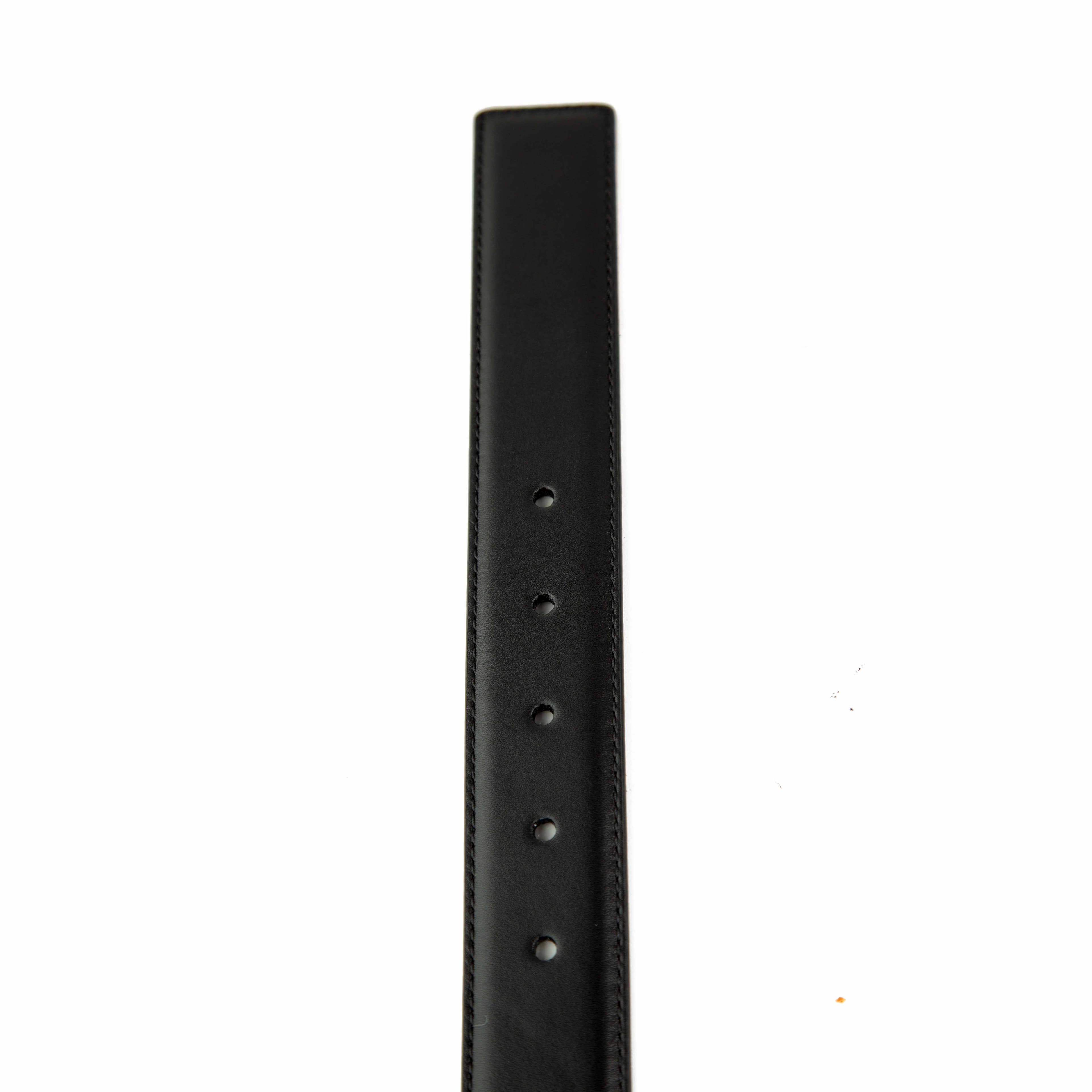 This sophisticated belt offers a unique twist on classic design with its distinctive dual-buckle system.