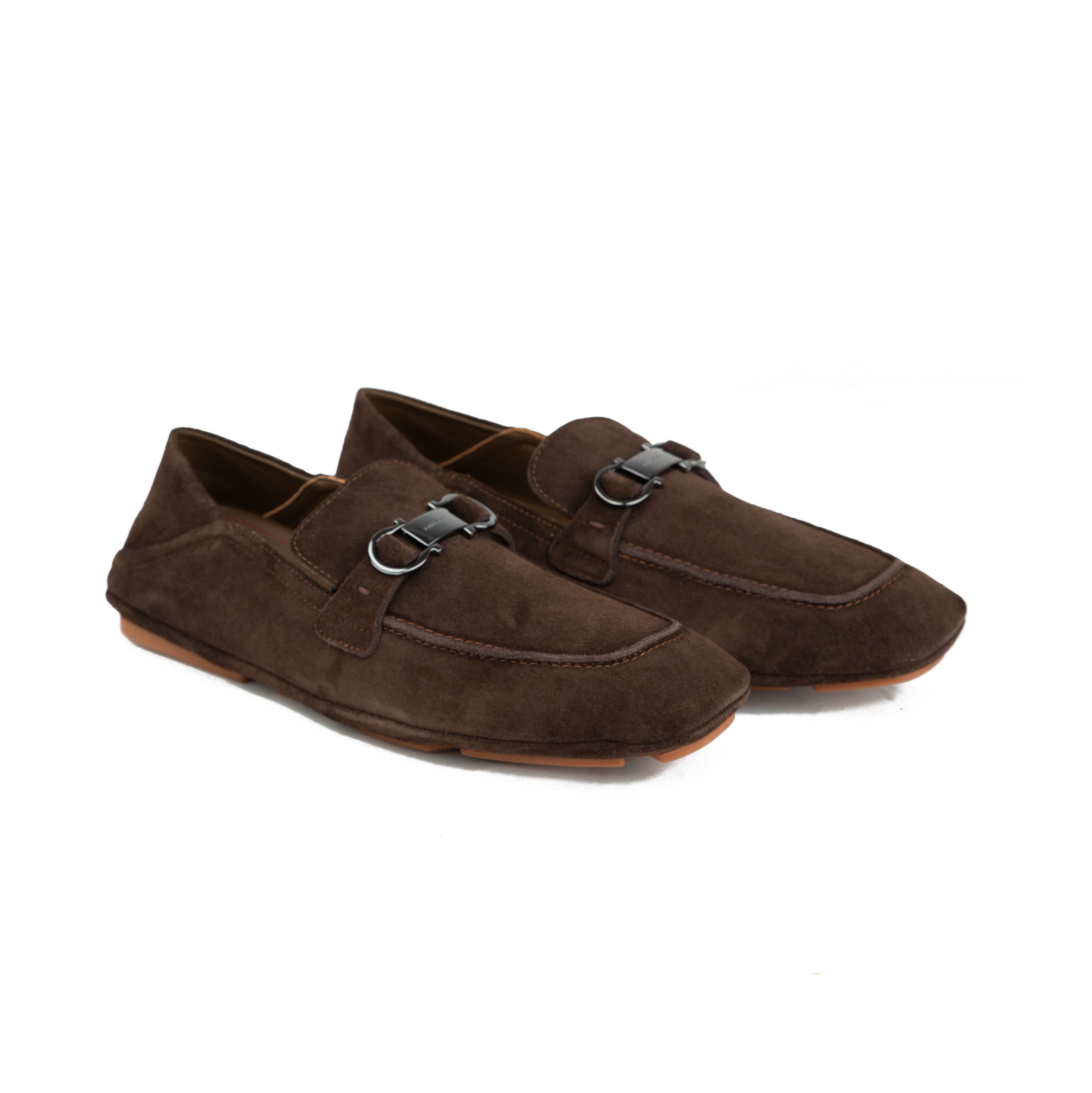 Chocolate brown suede Ferragamo Gancini loafers with collapsible heel and gum sole on white background.