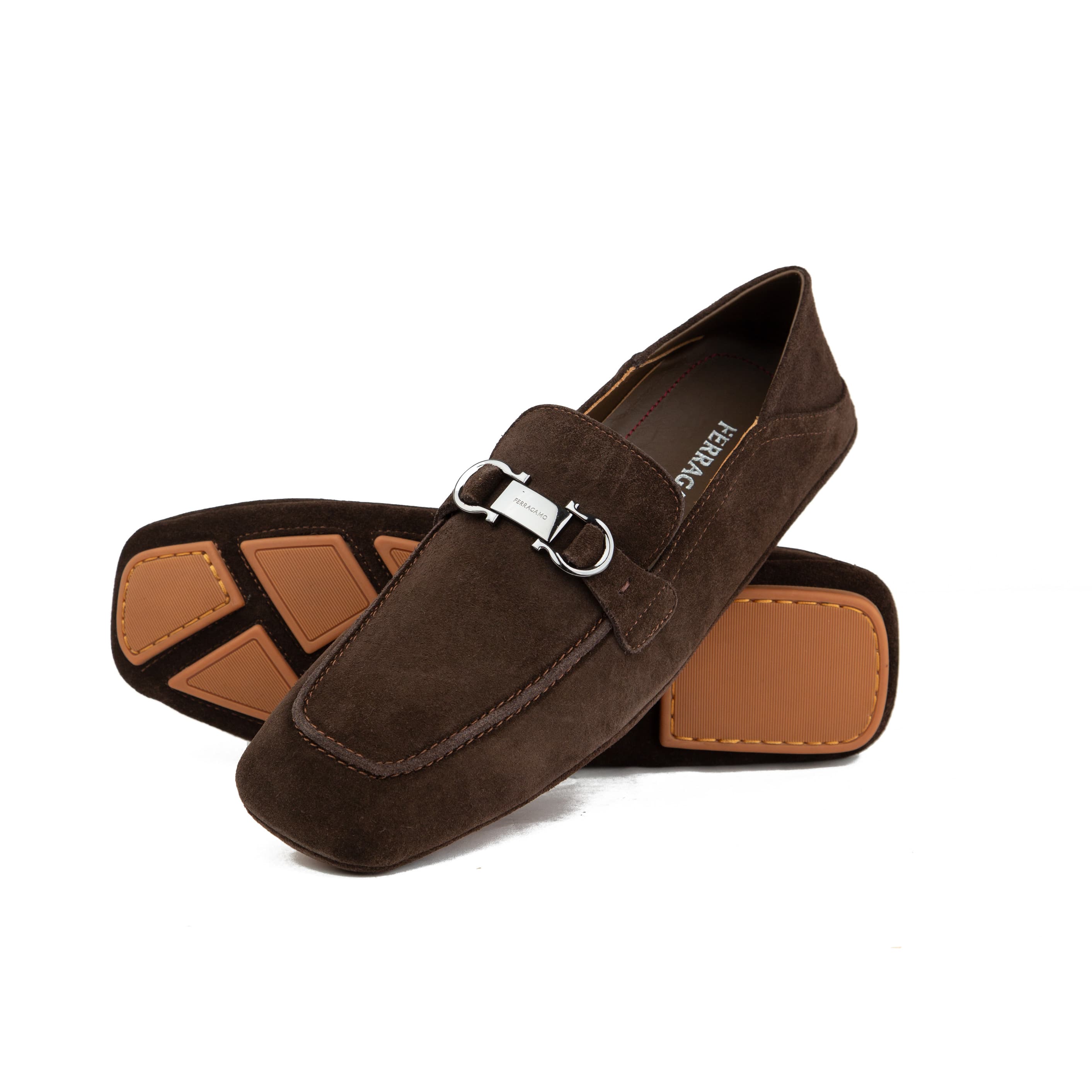 Chocolate brown suede Ferragamo Gancini loafers with collapsible heel and gum sole on white background.