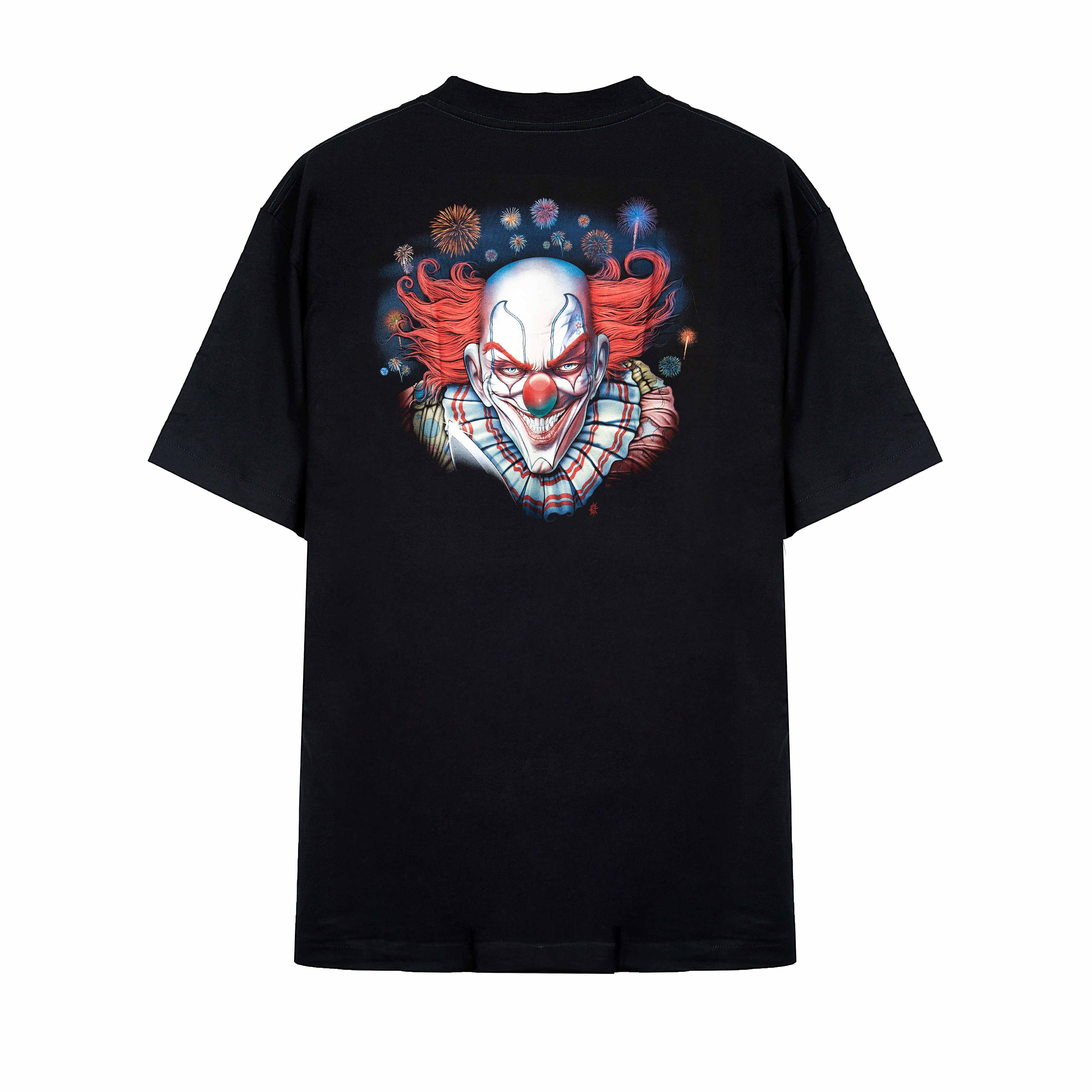 Rock Eagle black unisex t-shirt with a full-body graphic of a scary clown with red hair standing in a dilapidated, colorful carnival background.