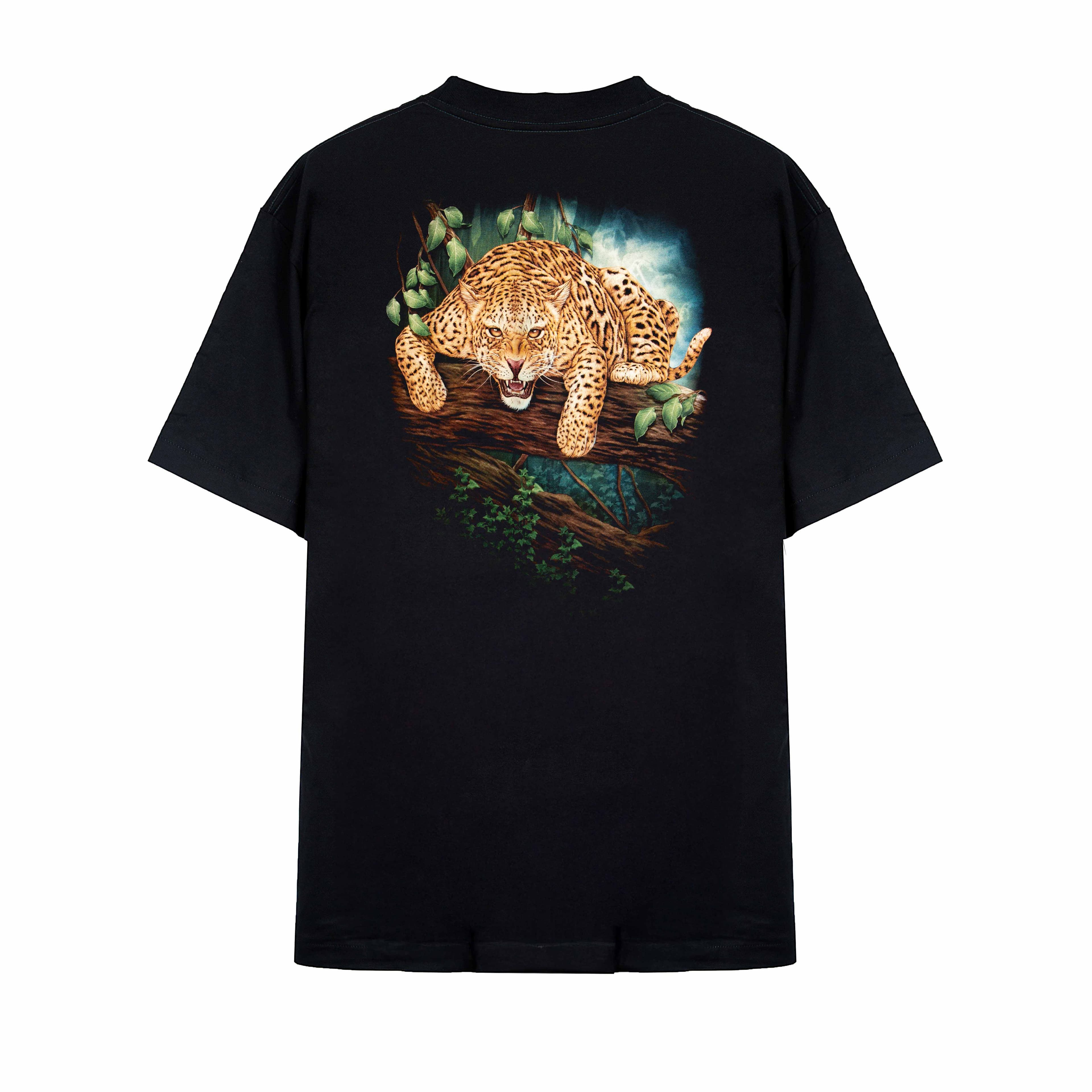 Rock Eagle black unisex t-shirt with a fierce, realistic graphic of a jaguar crouching on a jungle tree branch, staring forward with an open mouth.