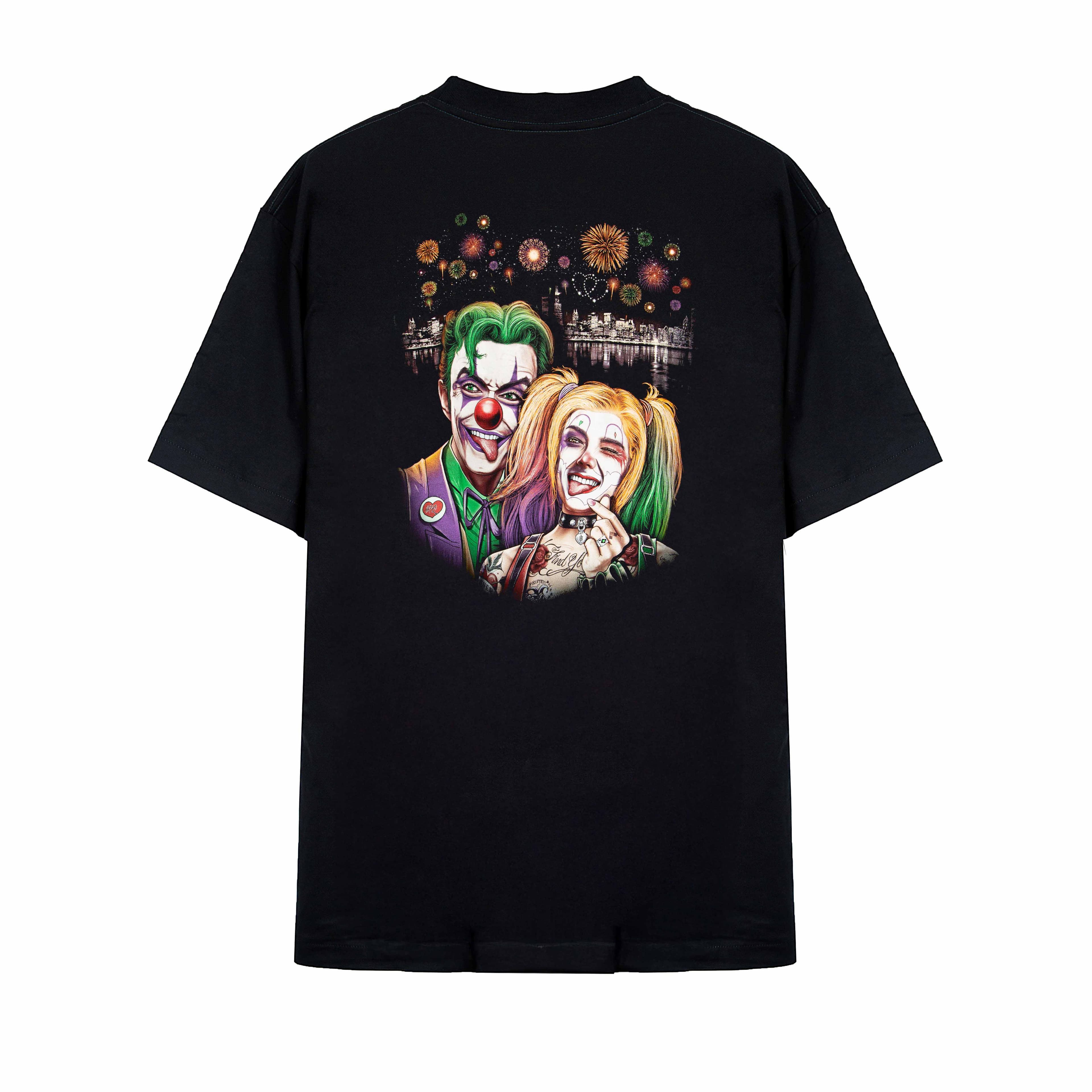 Rock Eagle black unisex t-shirt with a detailed graphic of the Joker and Harley Quinn taking a selfie against a night city skyline with fireworks.