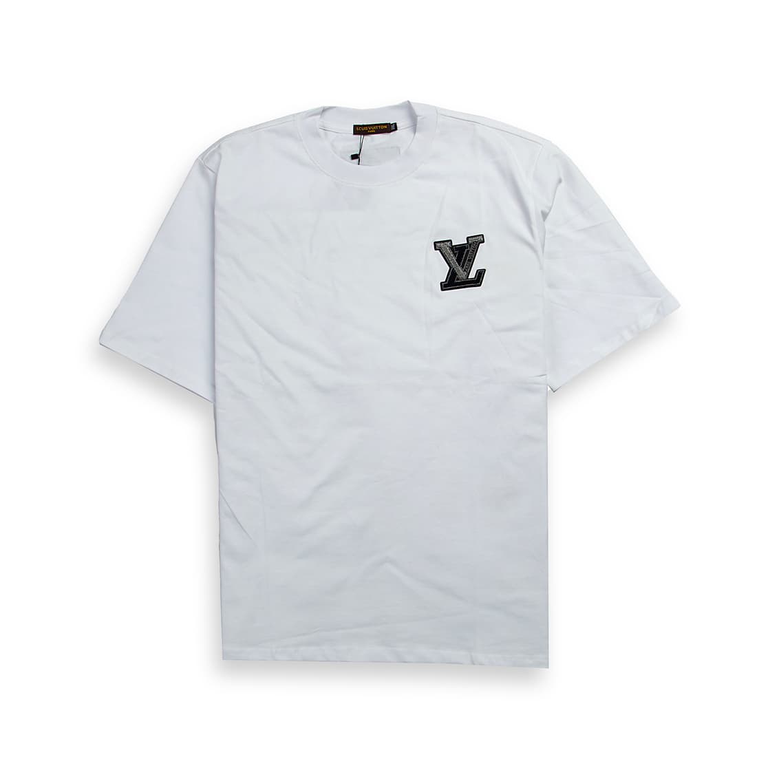A clean, plain white, short-sleeved, crew-neck t-shirt. It features a small, striking appliqué patch on the left chest.