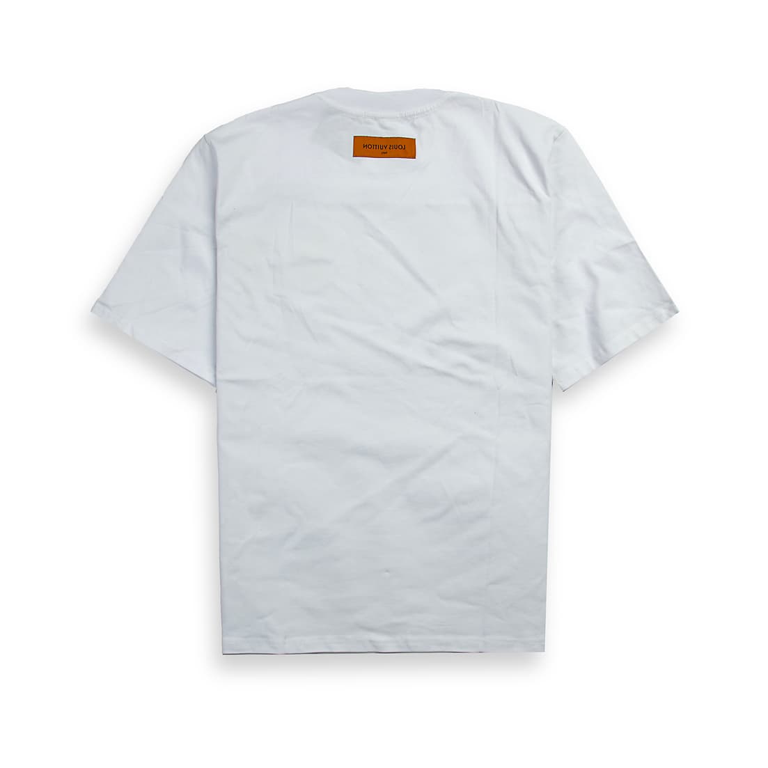 A clean, plain white, short-sleeved, crew-neck t-shirt. It features a small, striking appliqué patch on the left chest.