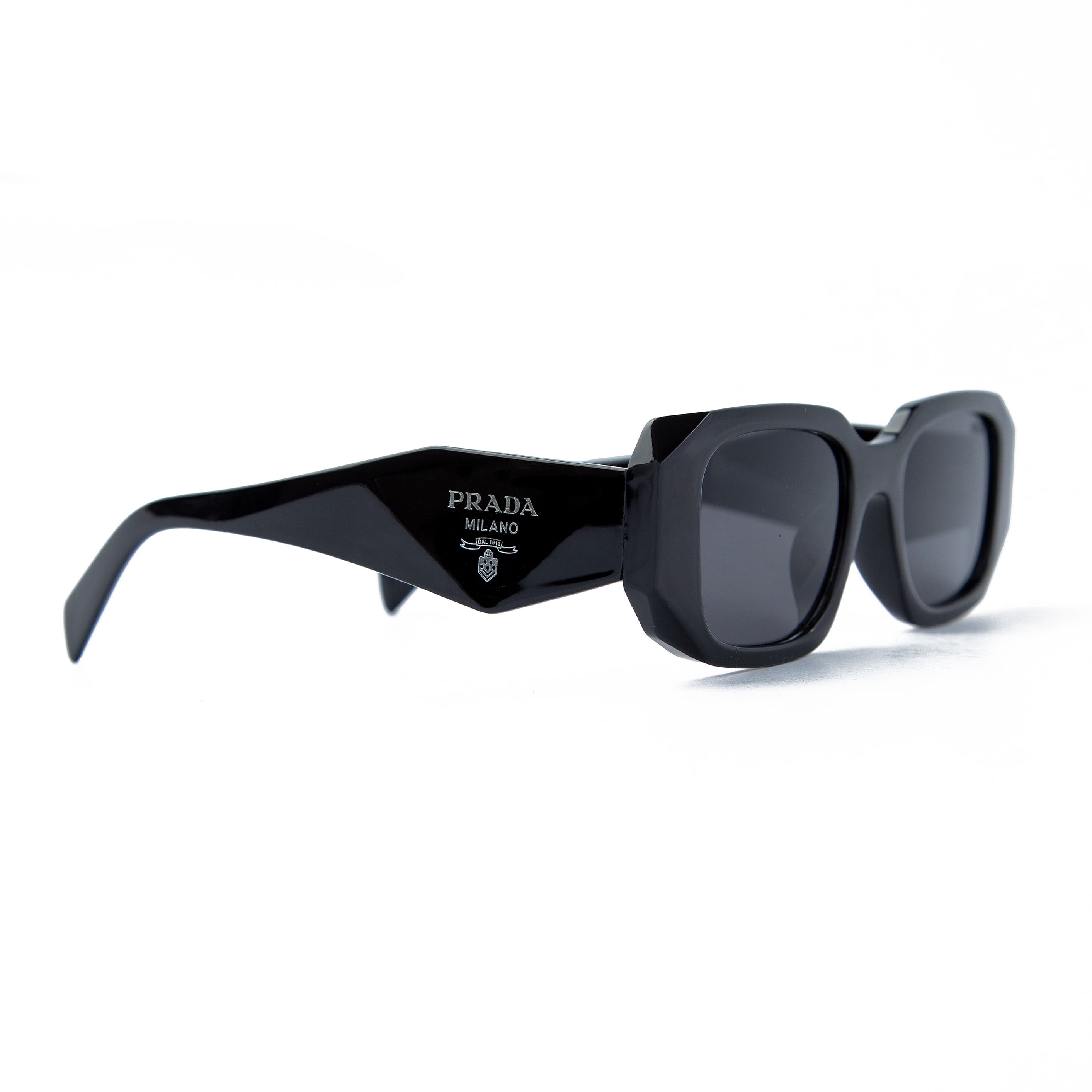 Prada rectangular black sunglasses with dark tinted lenses and Prada Milano logo detailing, offering bold unisex style and UV protection for fashion enthusiasts.