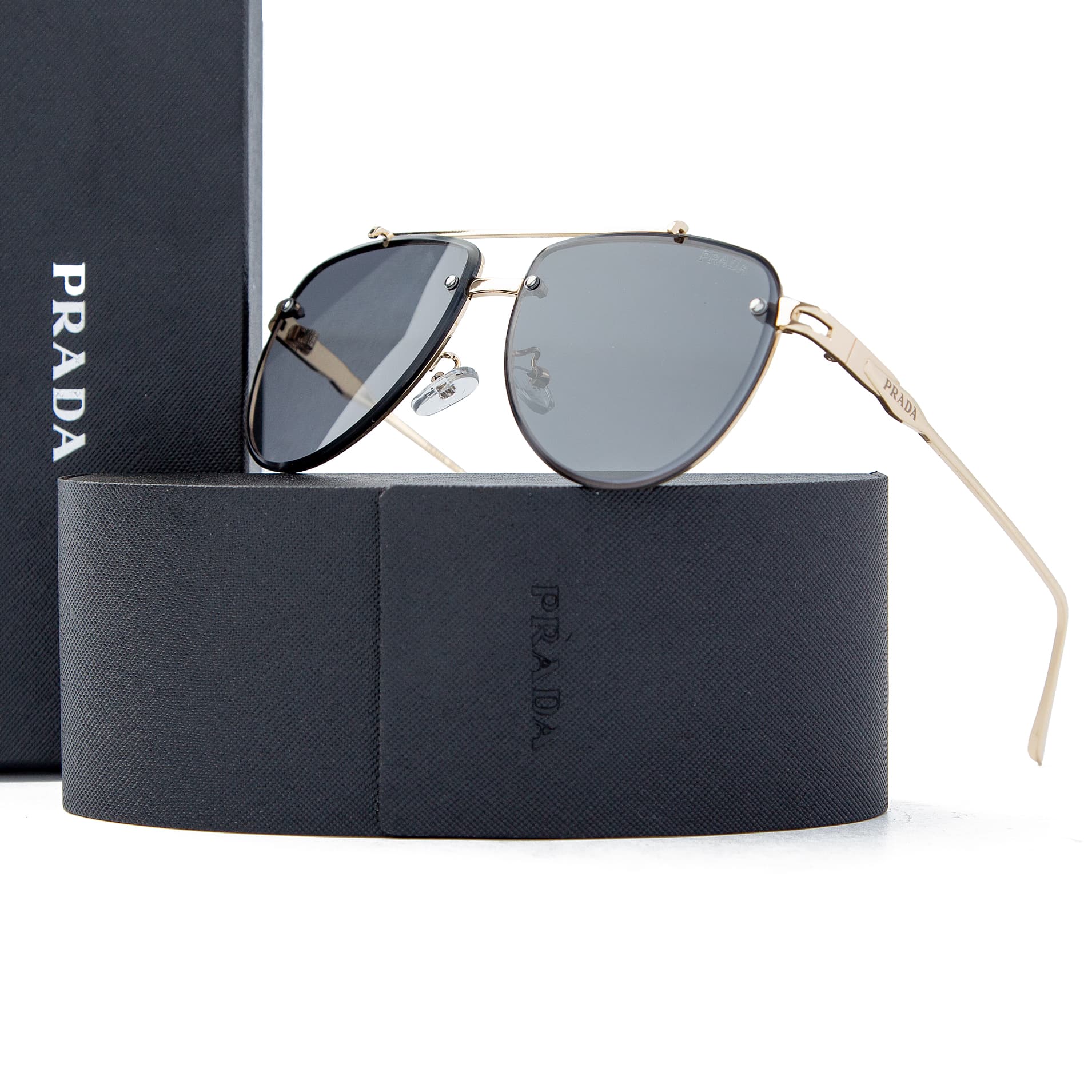 Prada gold aviator sunglasses with dark gray lenses, featuring a luxury gold-tone metal frame and Prada branding, offering UV protection and timeless style