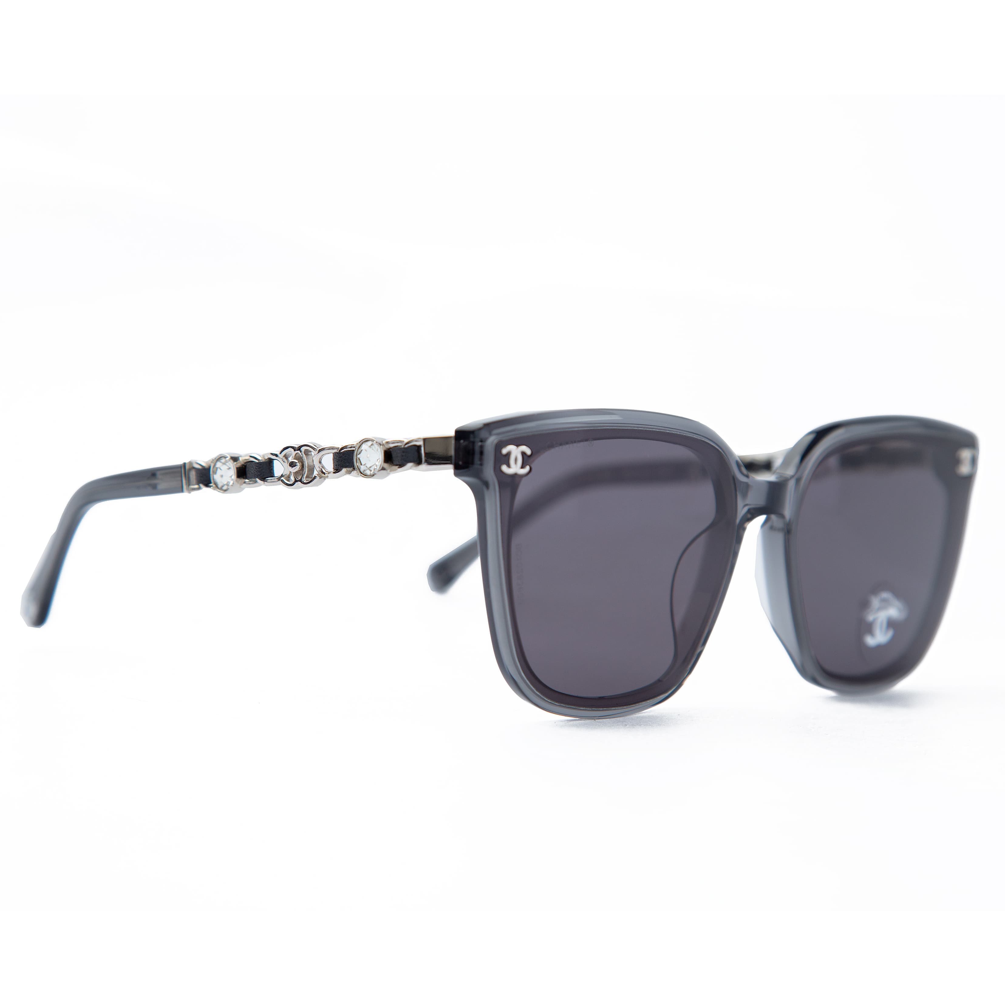 Chanel grey transparent square sunglasses for men with logo chain temples, luxurious eyewear offering UV protection and a modern, stylish look.