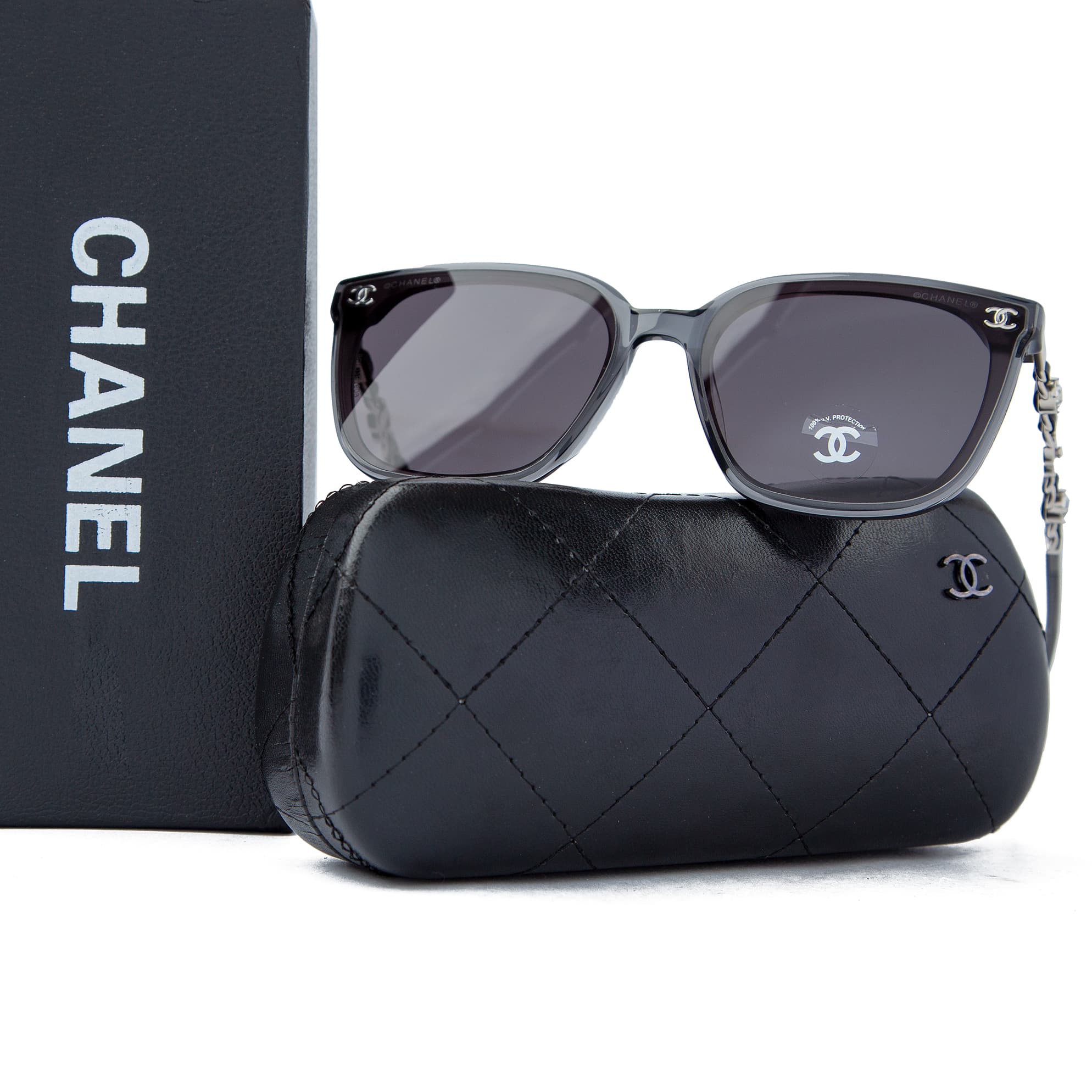 Chanel grey transparent square sunglasses for men with logo chain temples, luxurious eyewear offering UV protection and a modern, stylish look.