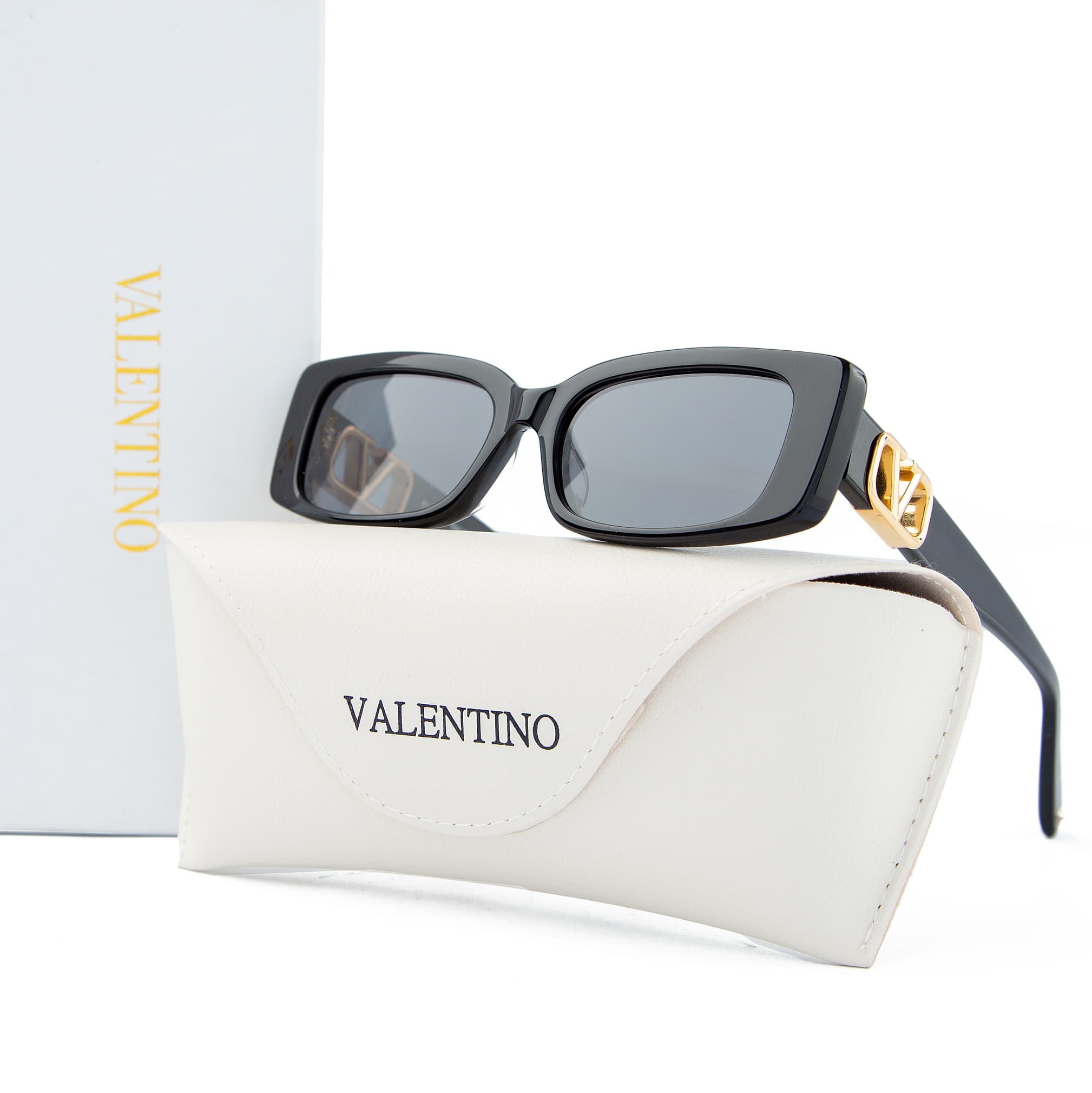 Valentino rectangular black sunglasses with gold logo accents and grey-tinted lenses. Unisex designer eyewear for a luxurious and stylish look.