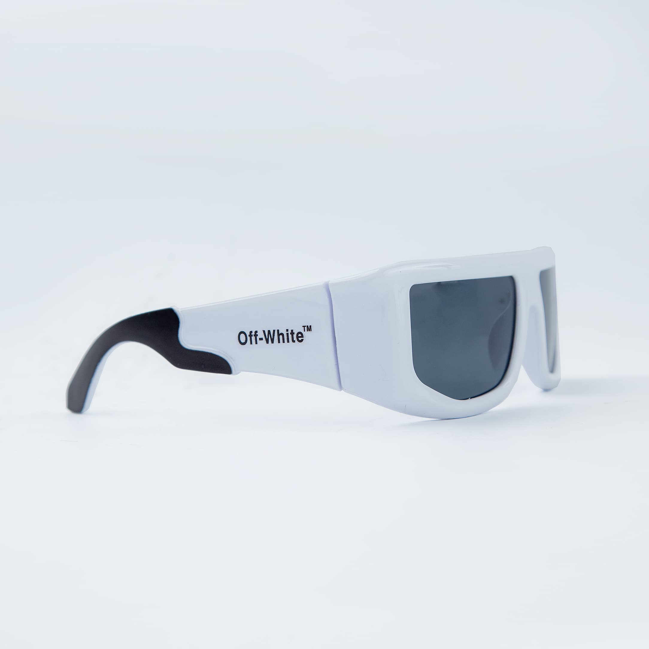 Off-White rectangular white sunglasses with black-tinted lenses, featuring a bold and modern design. Unisex eyewear for a stylish and contemporary look
