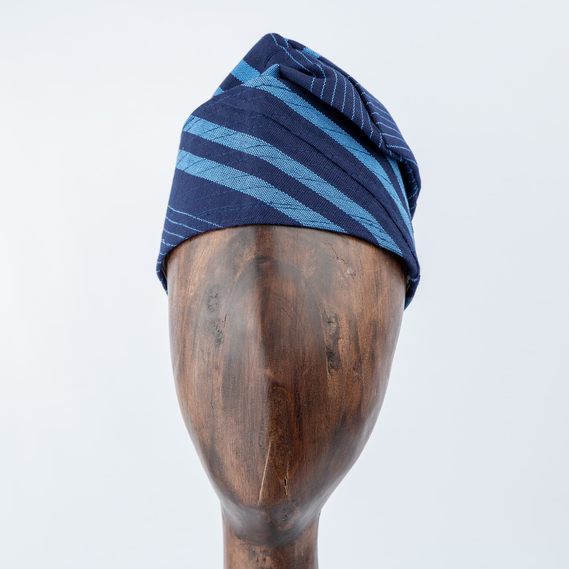 Unisex navy blue Aso Oke cap with diagonal light blue stripe design, premium handwoven traditional headwear for weddings, events, and special occasions
