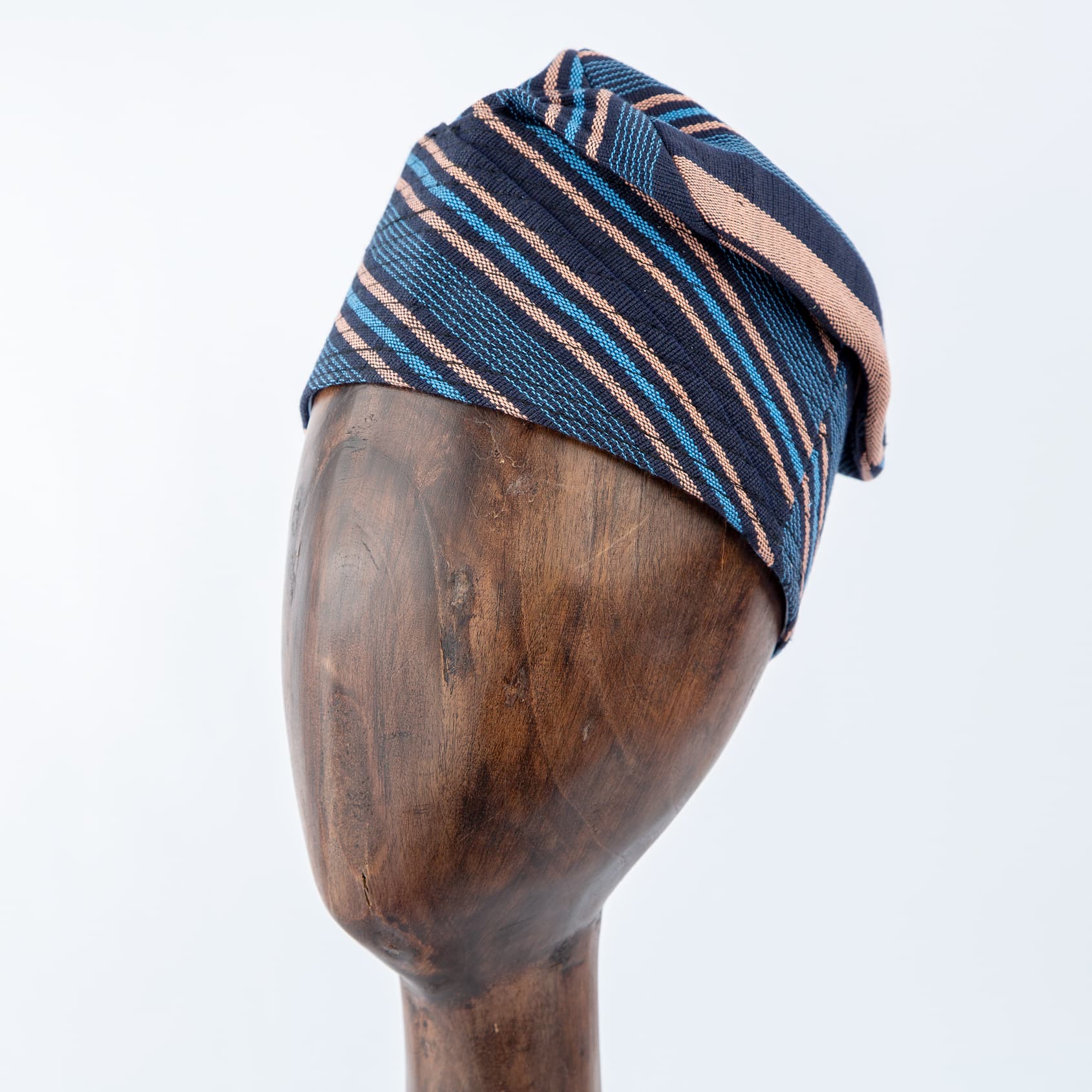 Elegant blue Aso Oke cap with peach stripe accents, unisex traditional headwear for cultural events and celebrations.