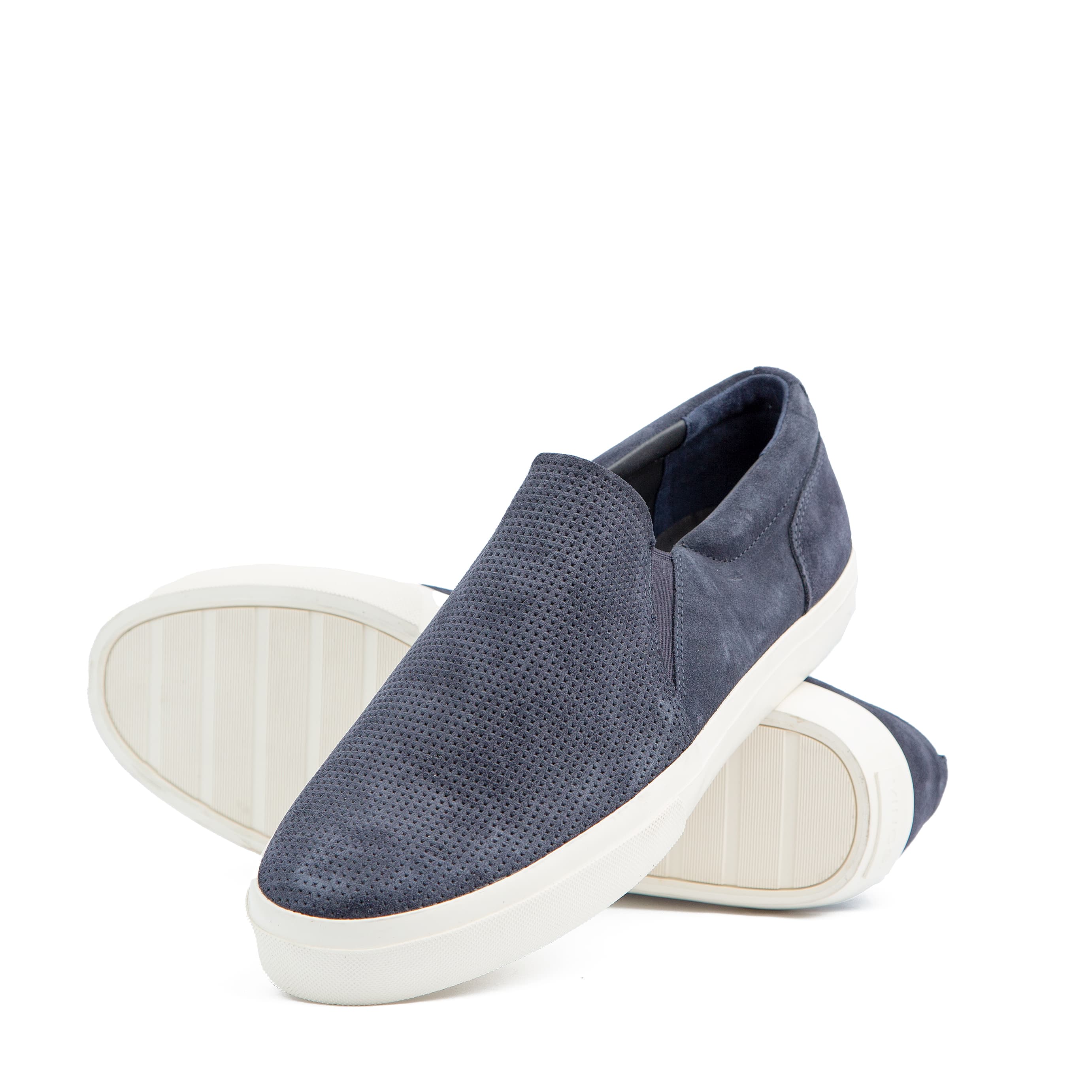 Perforated navy suede slip-on sneakers with white rubber sole – unisex casual footwear for style and comfort.