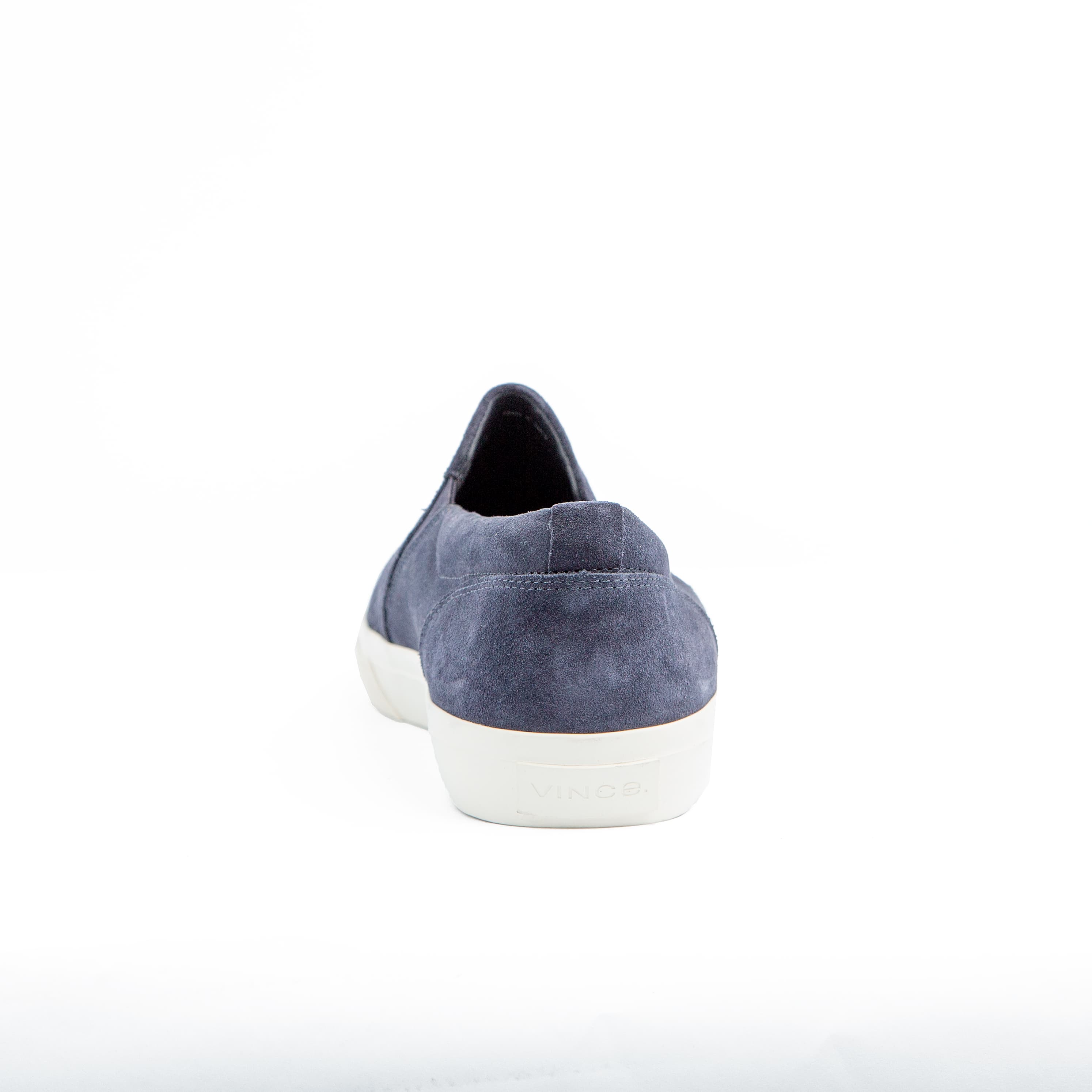 Perforated navy suede slip-on sneakers with white rubber sole – unisex casual footwear for style and comfort.