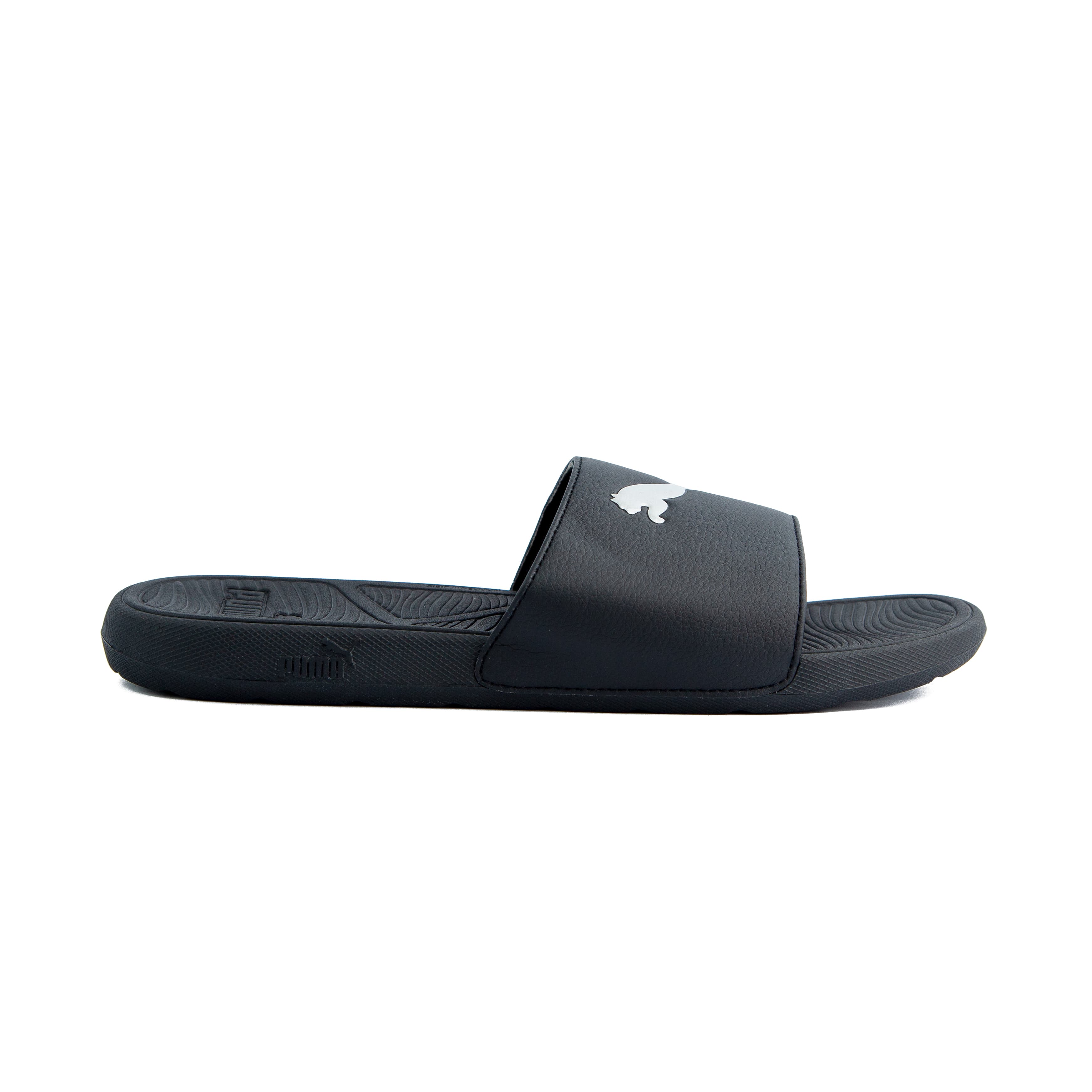 Black Puma slide sandals with white logo, unisex design, durable strap, and comfortable textured footbed for casual wear and relaxation.