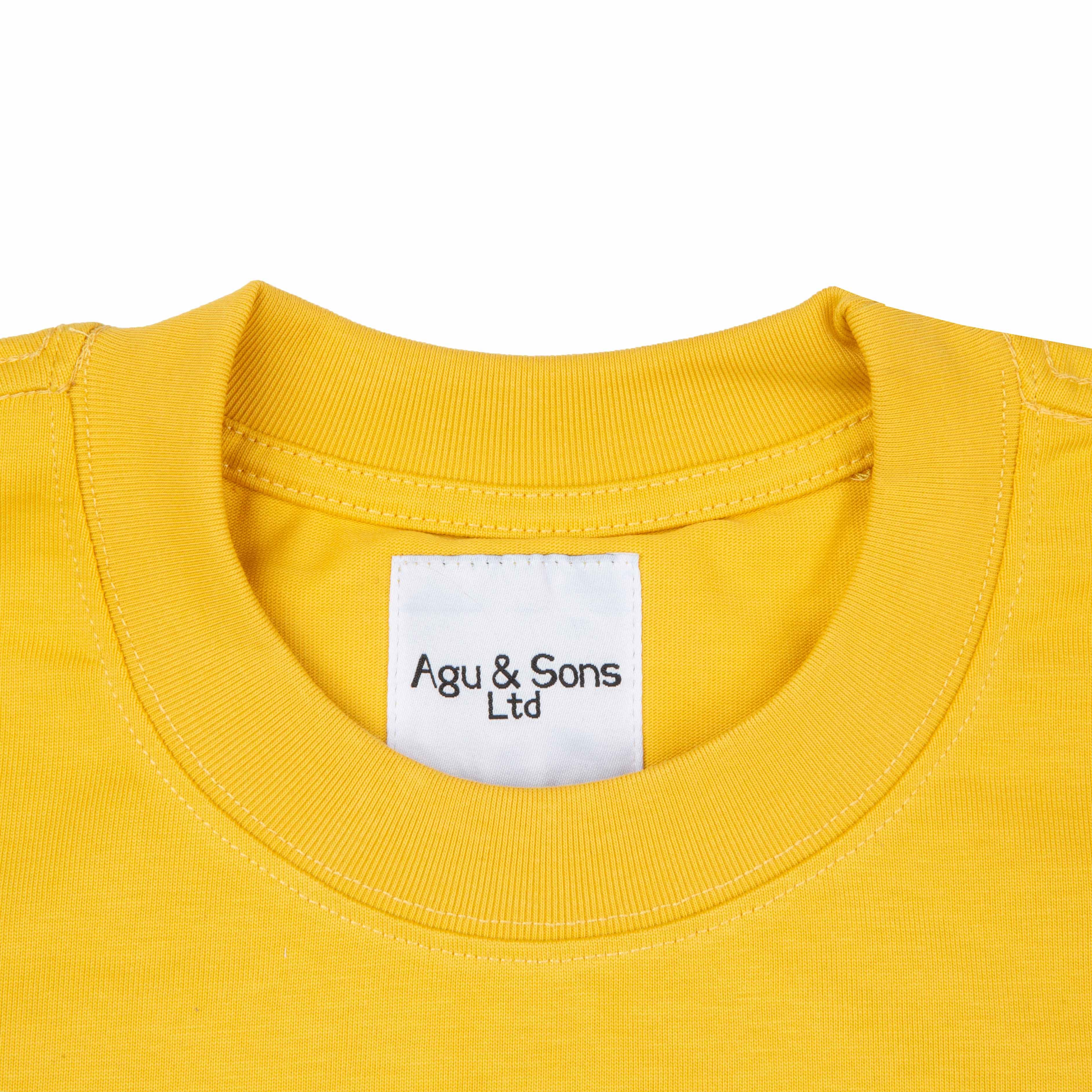 Agu & Sons yellow t-shirt with a distressed black smiley face design.