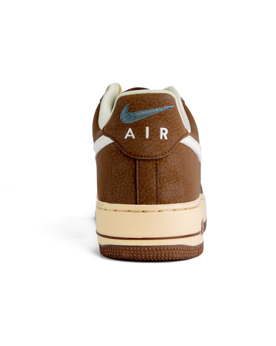 Classic brown and white low-top sneakers with cushioned soles, perfect for casual wear. Stylish, durable, and designed for ultimate comfort.