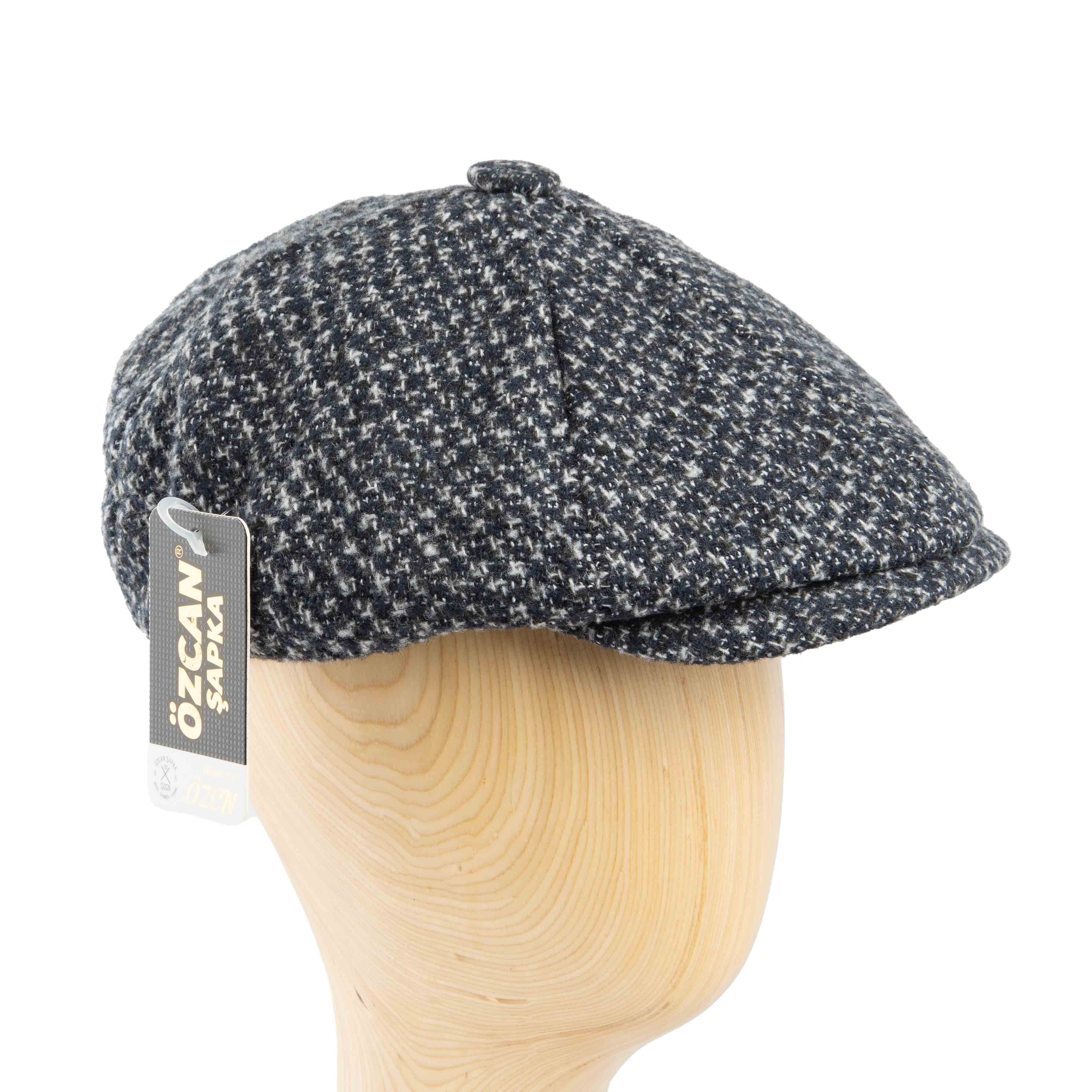Stylish black and white speckled tweed flat cap for men, perfect for a modern classic look.