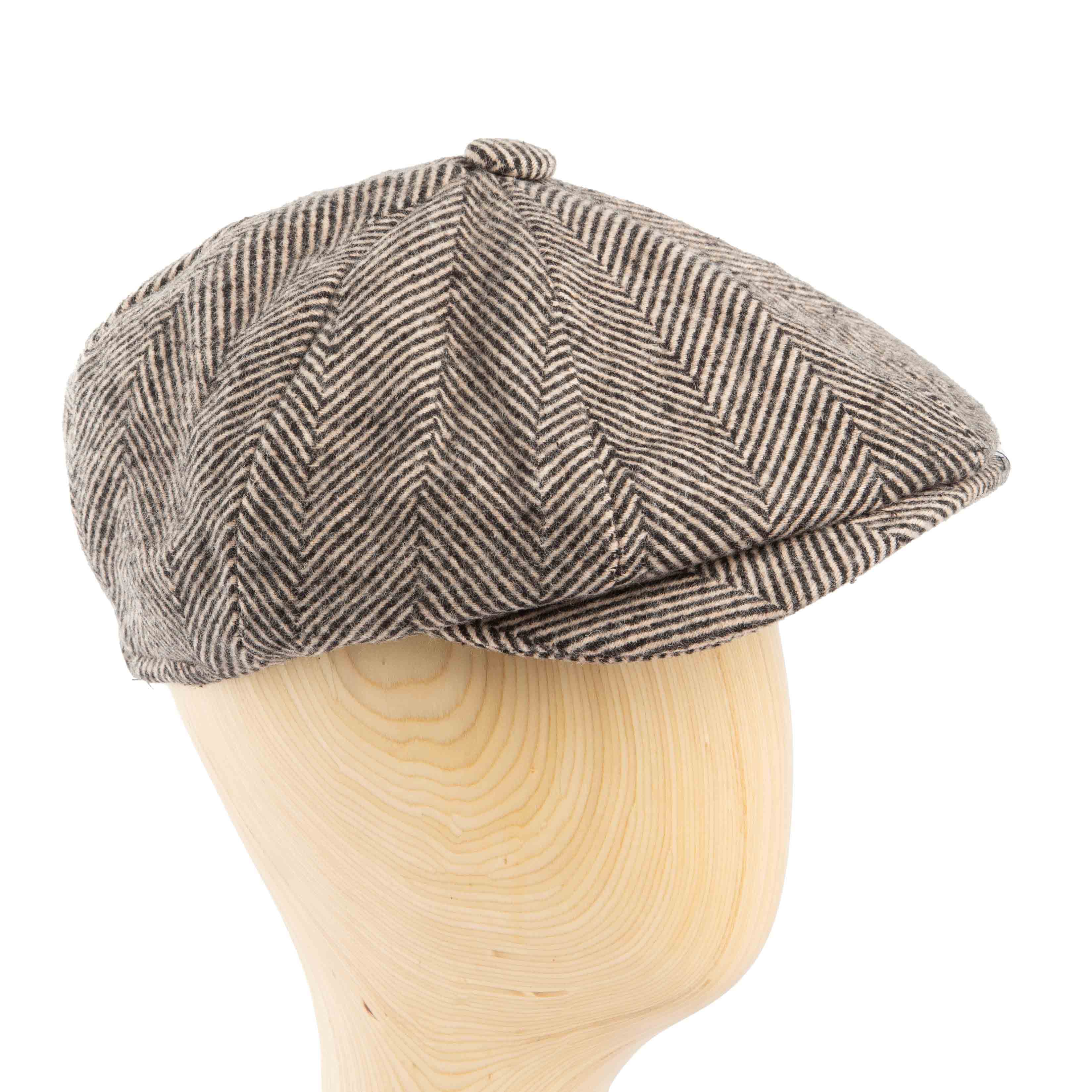 Classic black and white herringbone newsboy cap for men, perfect for vintage or versatile everyday wear.