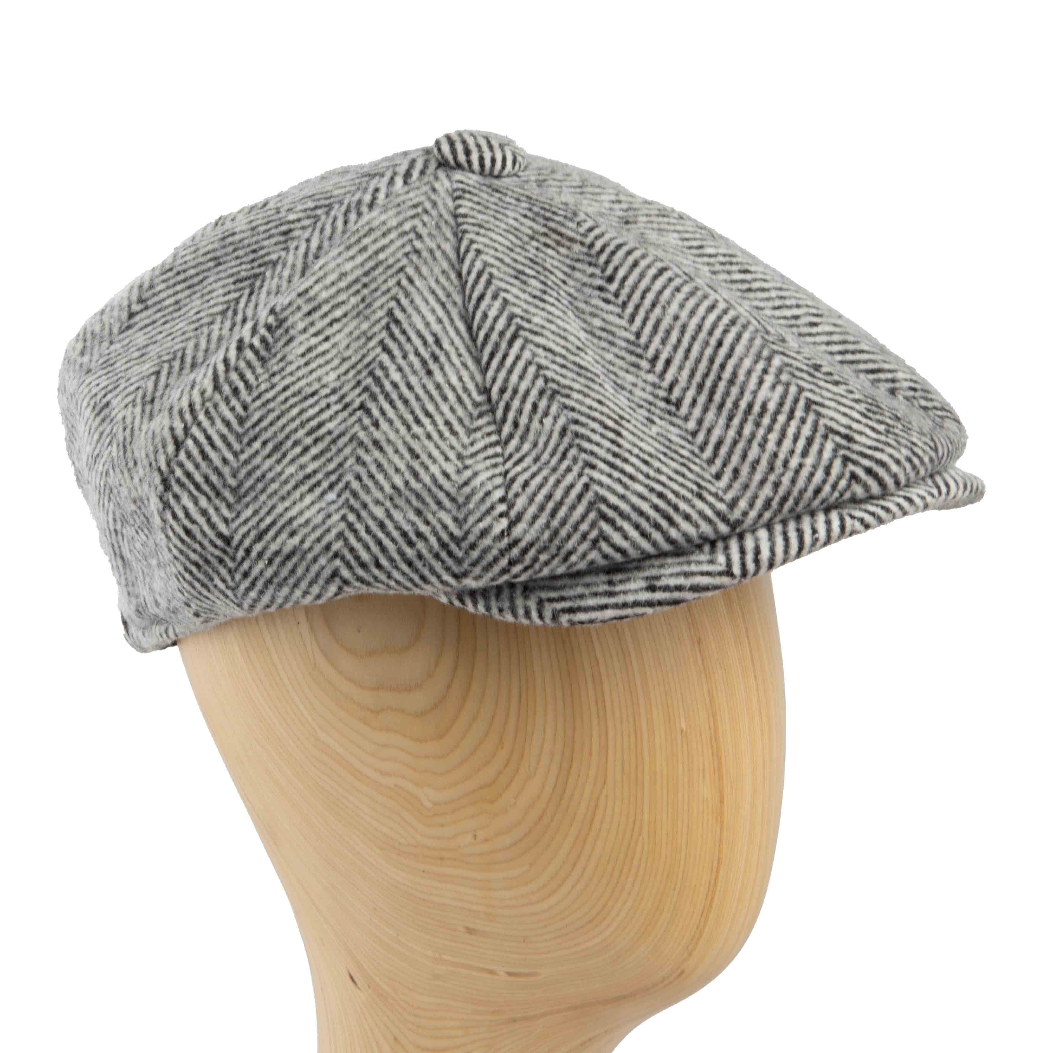 This is a classic newsboy cap featuring a prominent herringbone pattern in shades of grey and black.