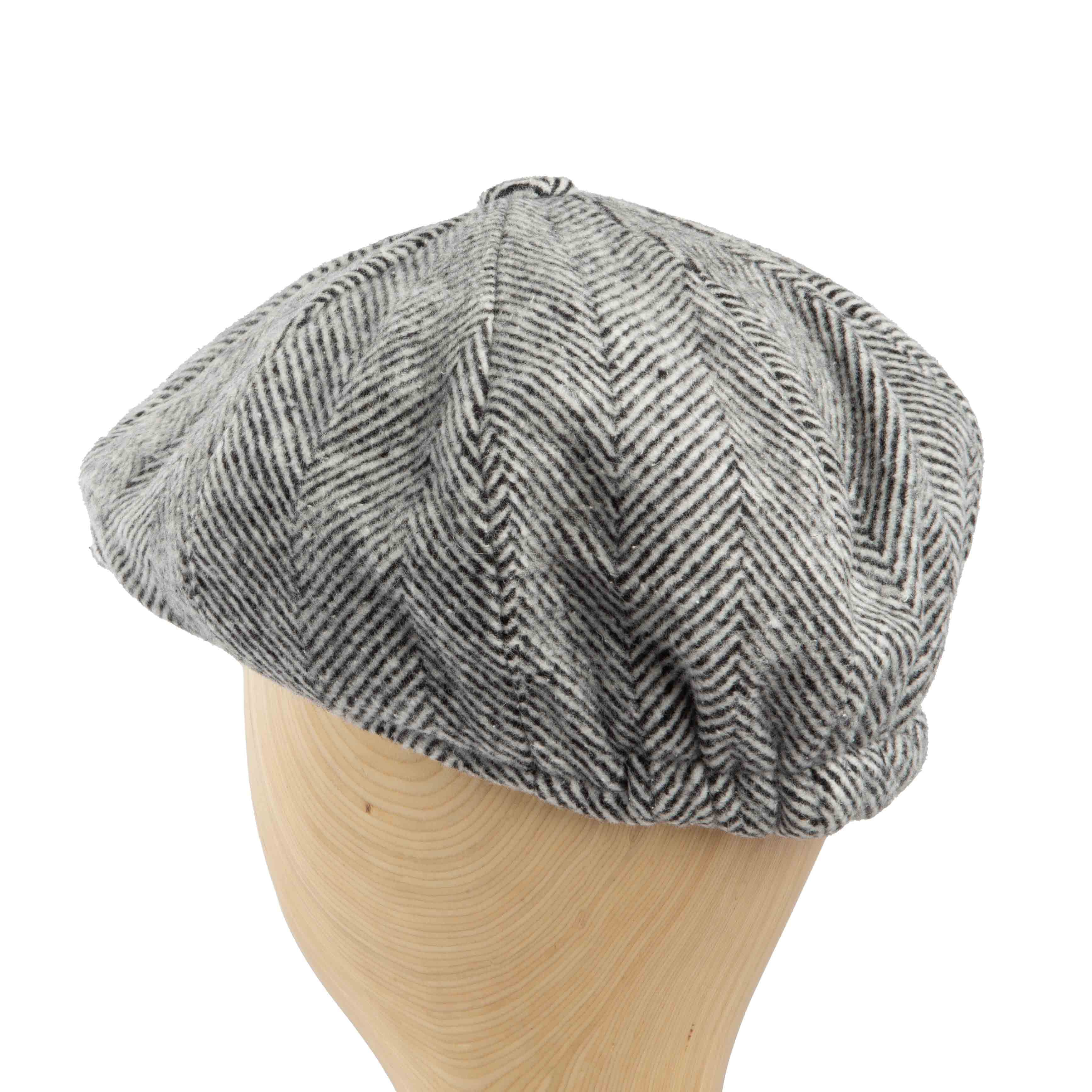 This is a classic newsboy cap featuring a prominent herringbone pattern in shades of grey and black.