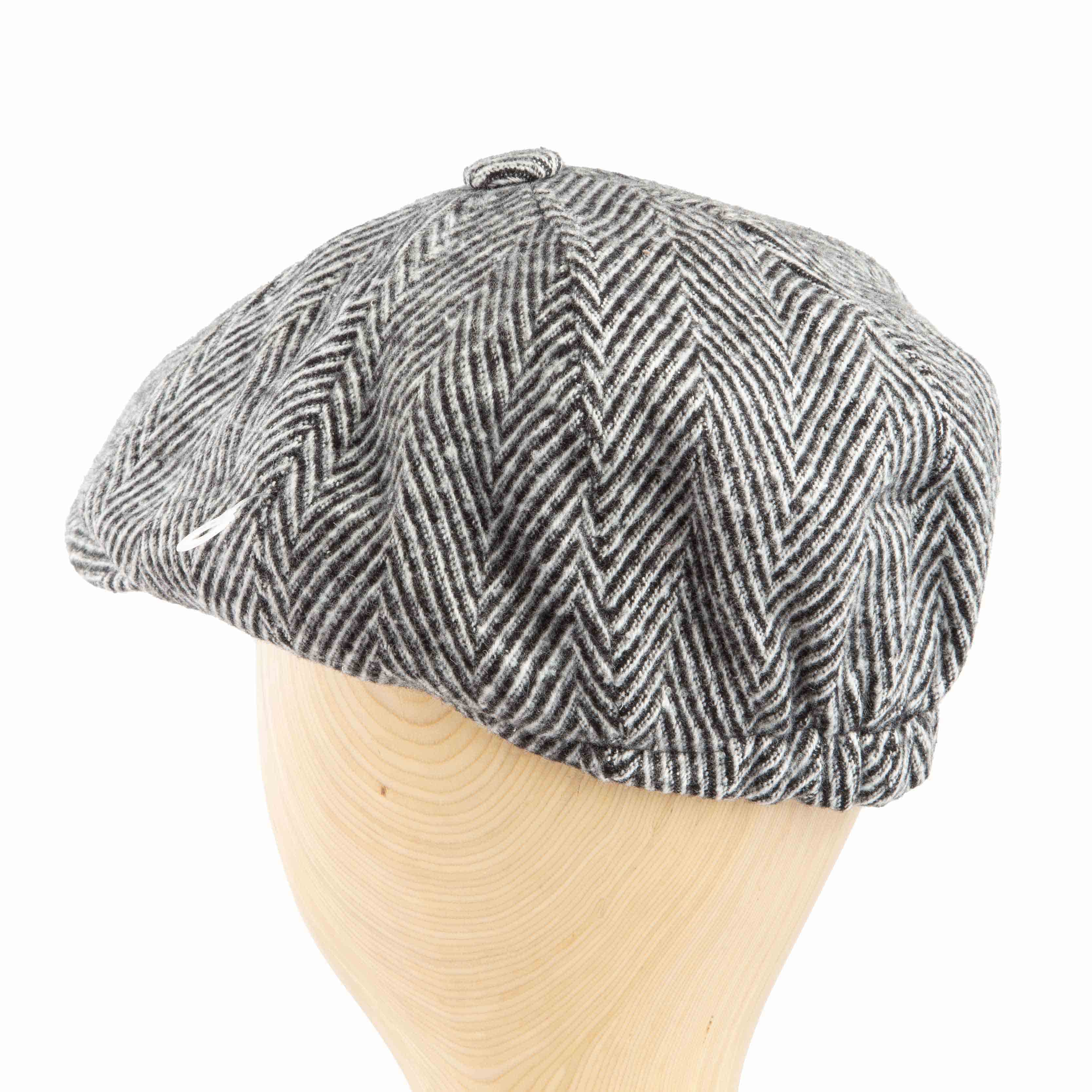 Grey and black herringbone flat cap with a classic newsboy design, perfect for adding a vintage and sophisticated touch to any outfit.