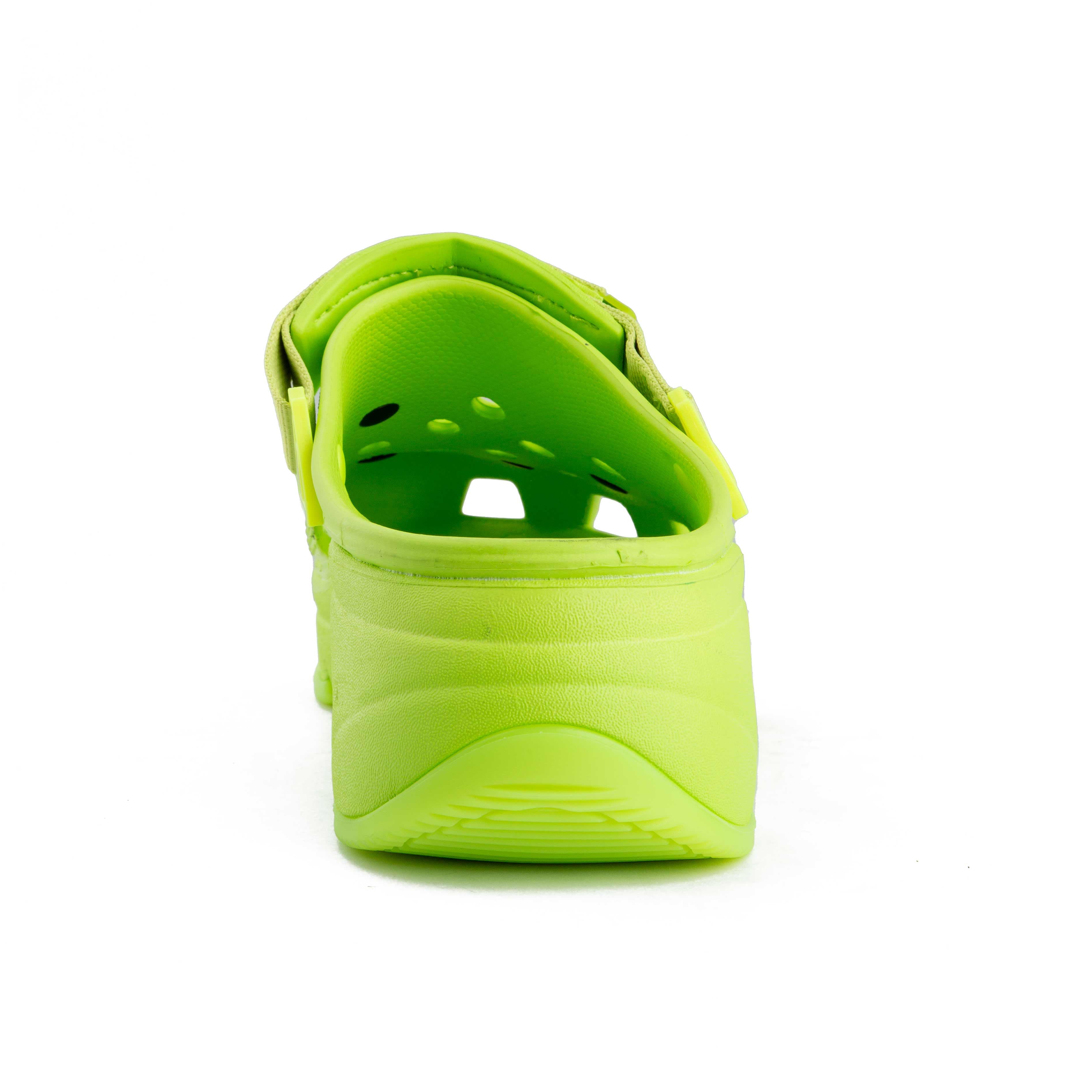 Lime green platform clogs with assorted colorful decorative charms, side view.