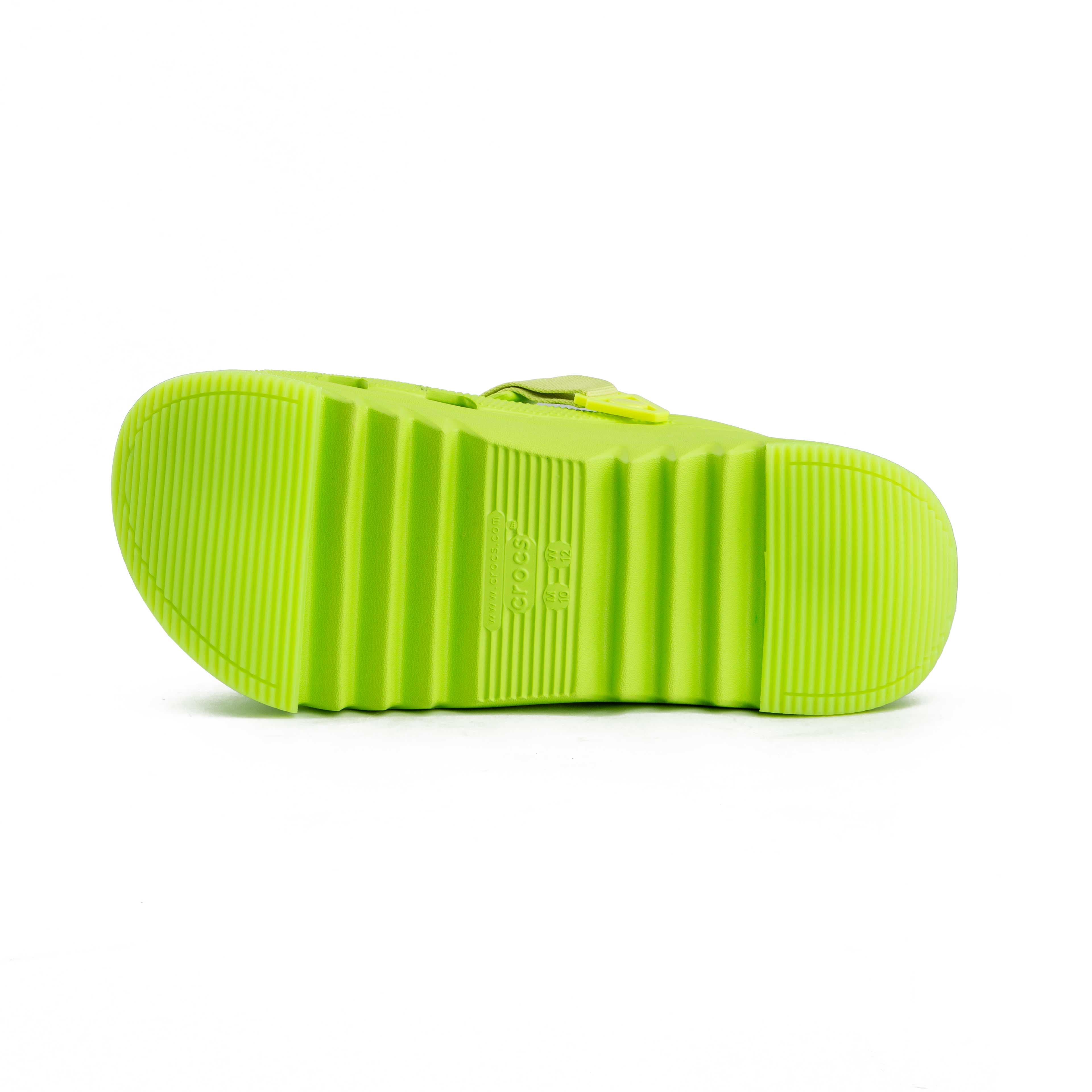 Lime green platform clogs with assorted colorful decorative charms, side view.