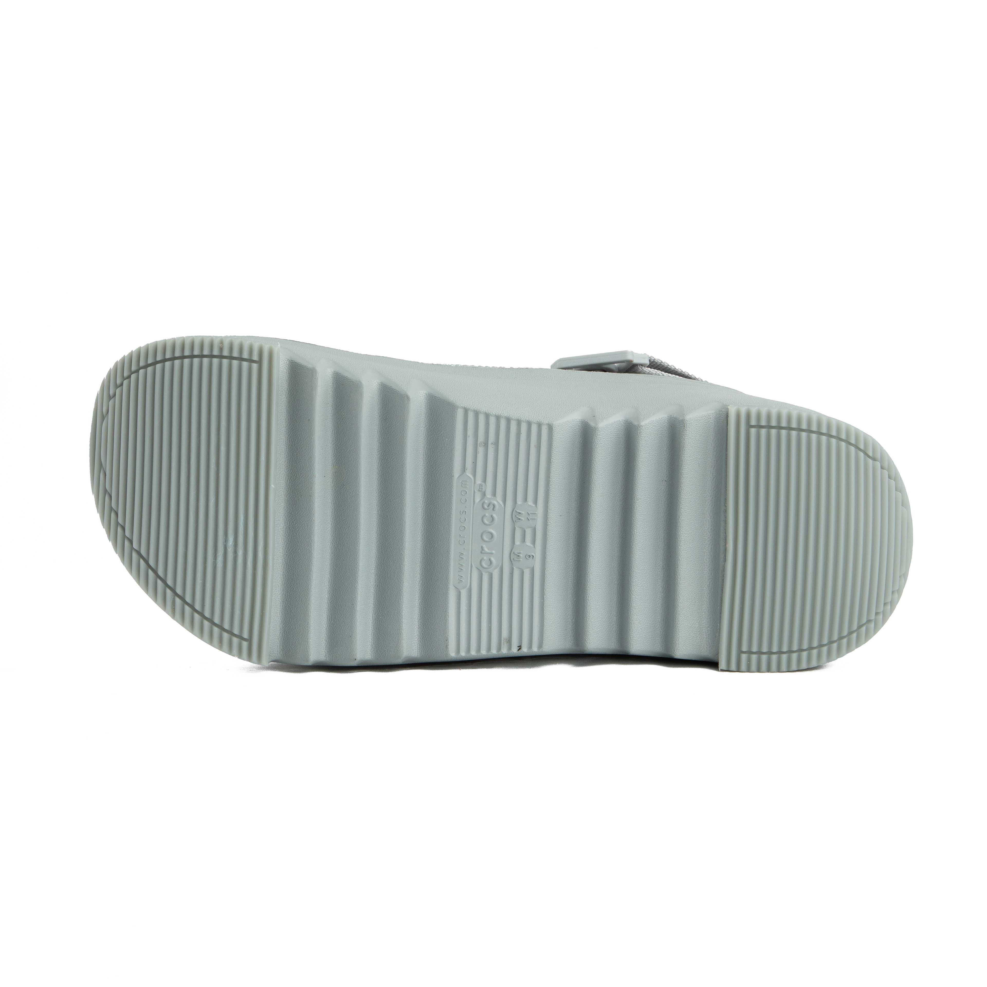 Grey platform clogs with assorted colorful character decorative charms, side view.