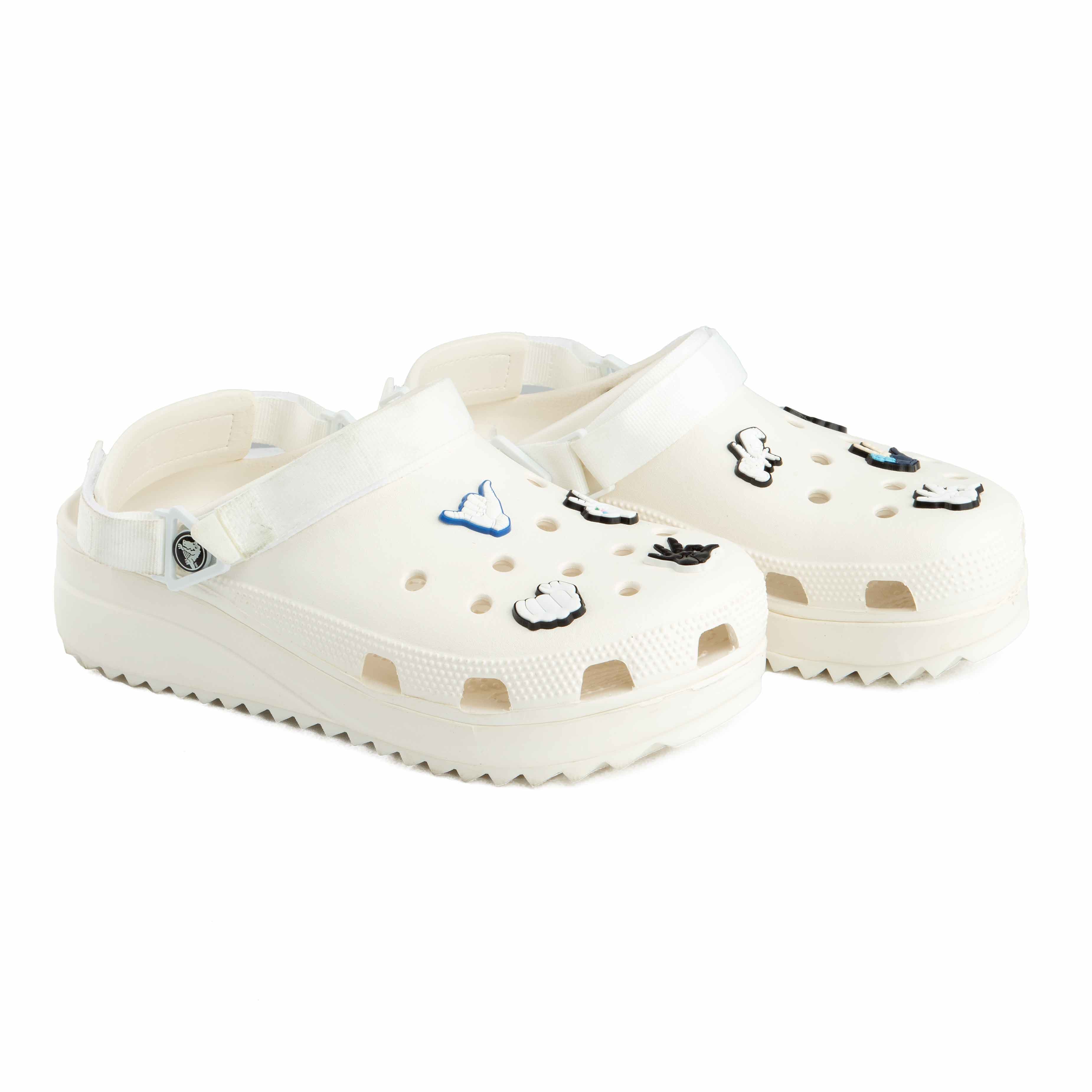 These are a pair of platform Crocs Classic Crush Clogs in an off-white or cream color. 