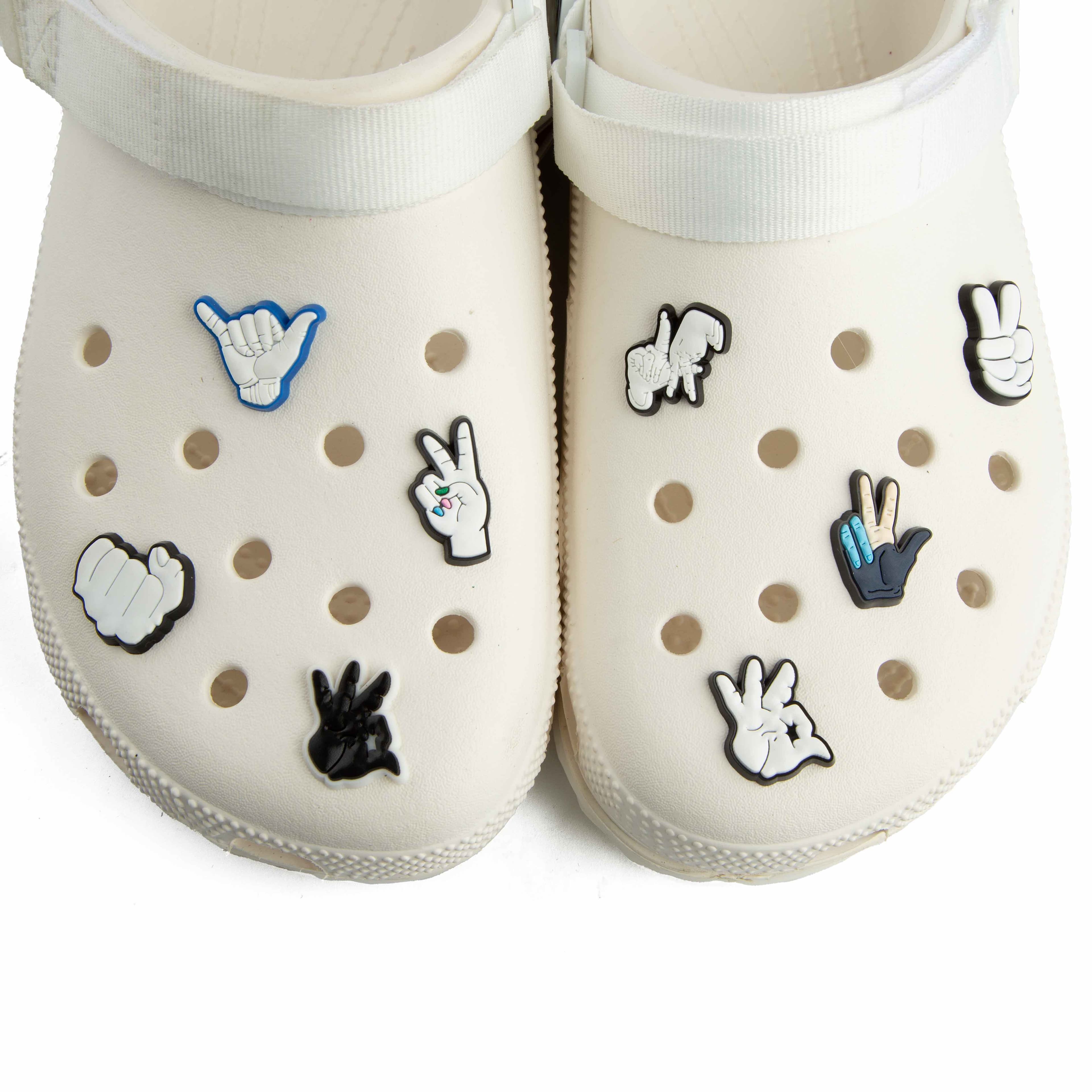 These are a pair of platform Crocs Classic Crush Clogs in an off-white or cream color. 
