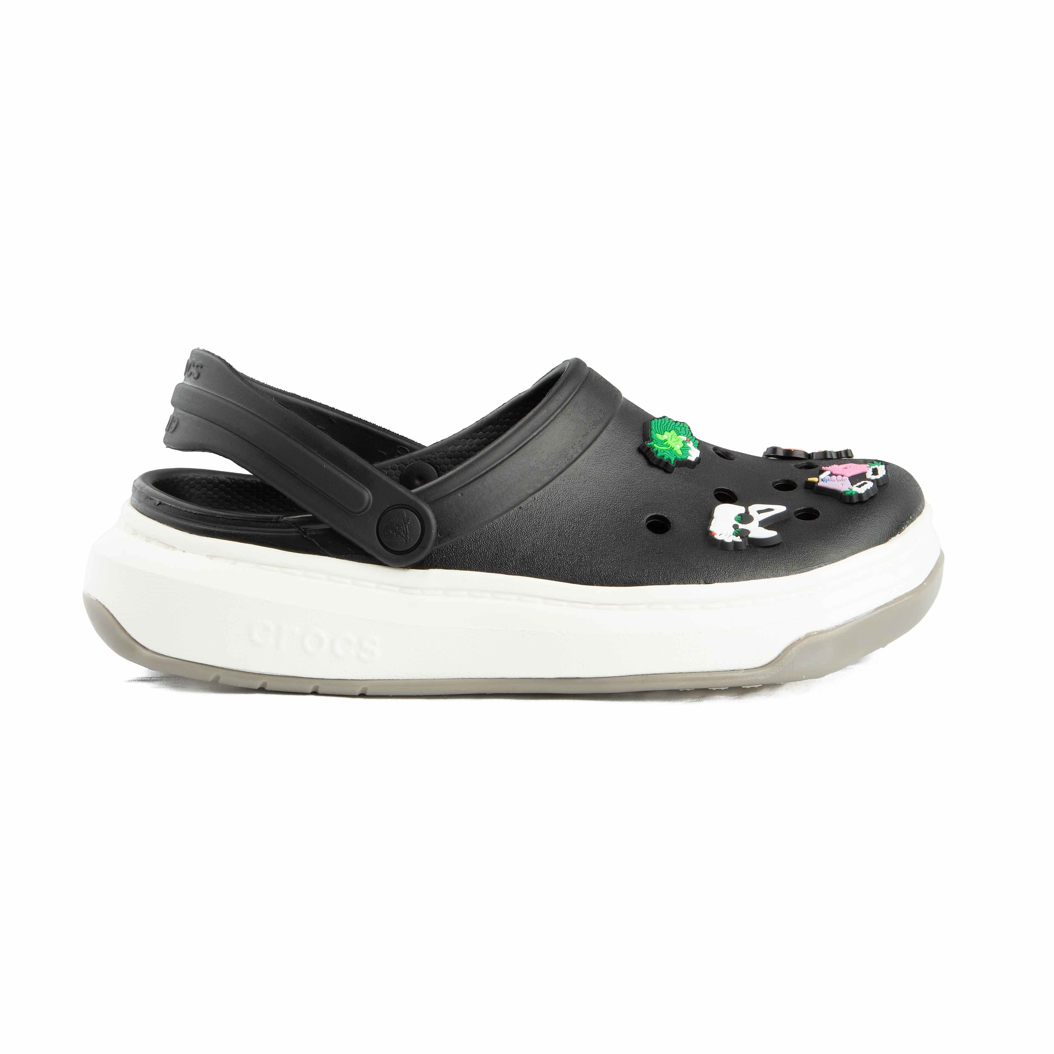 Two-tone black and white platform clogs, side view.