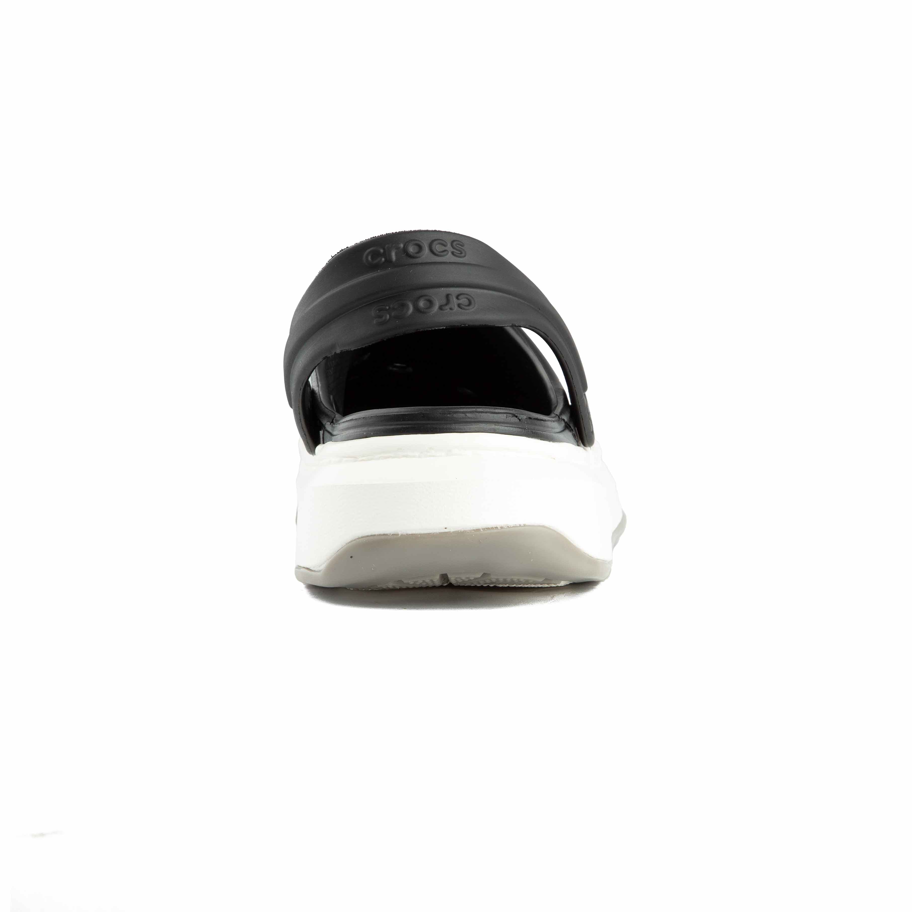 Two-tone black and white platform clogs, side view.