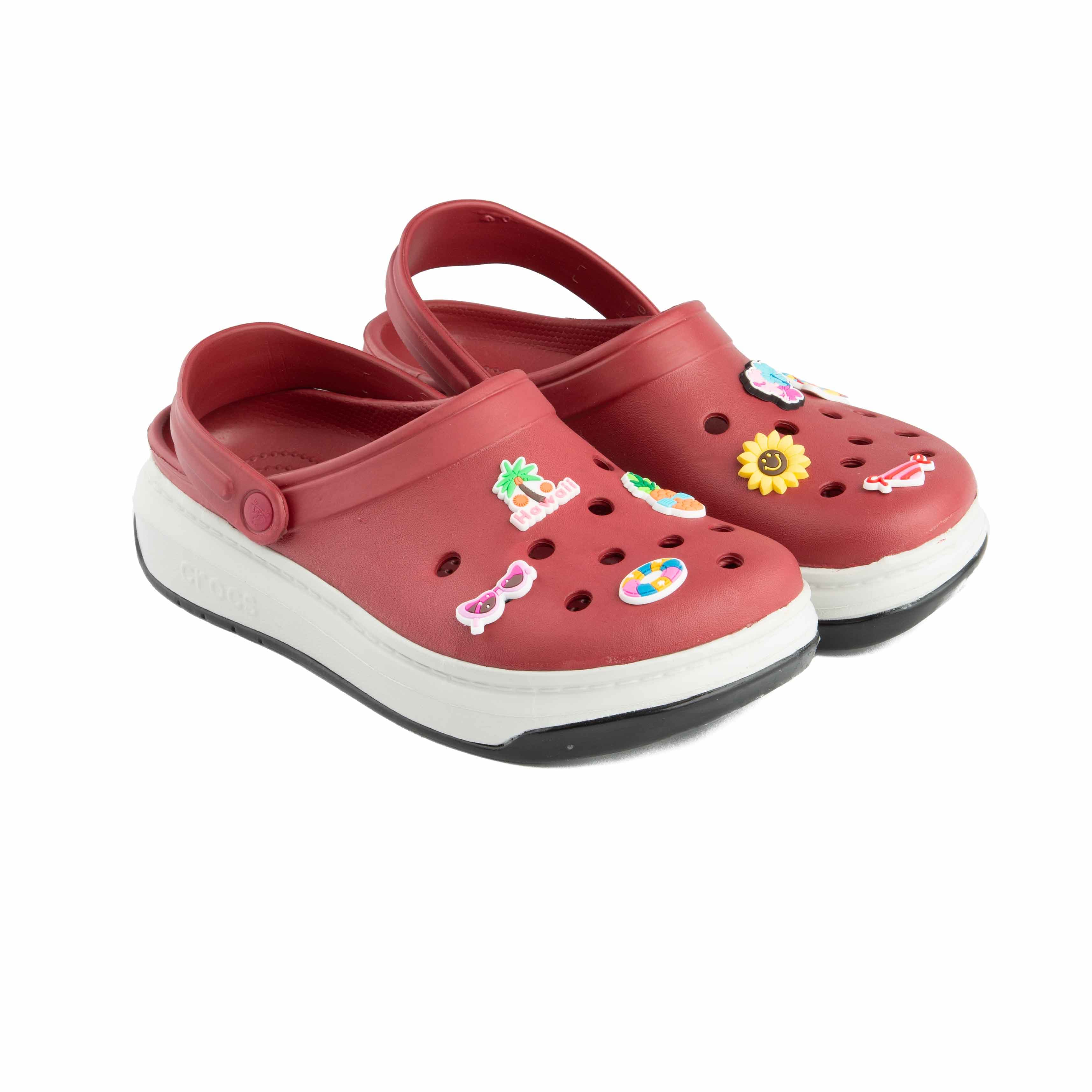 Maroon platform clogs with assorted colorful summer-themed decorative charms, side view.