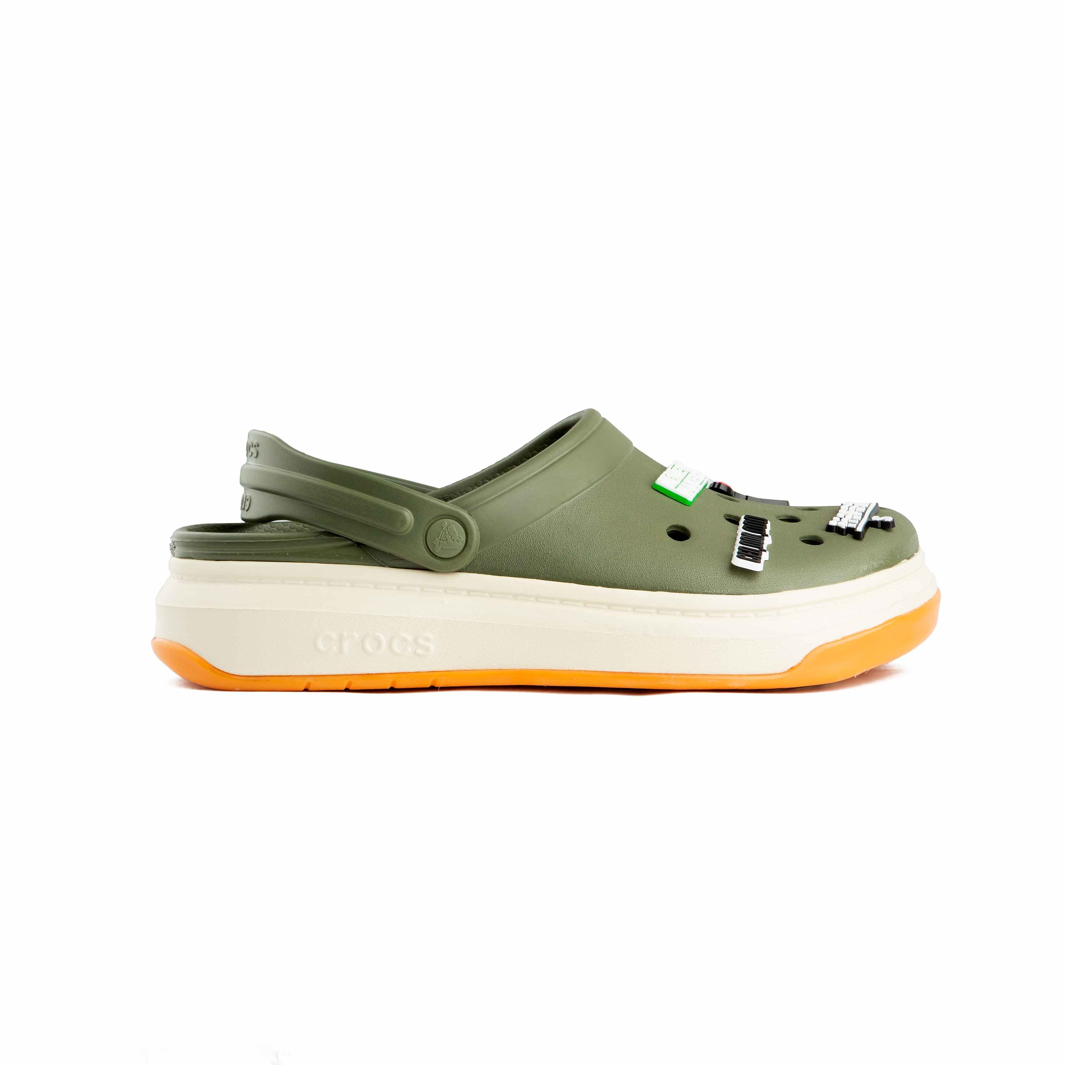 Olive green platform clogs with assorted urban and money-themed decorative charms, side view.