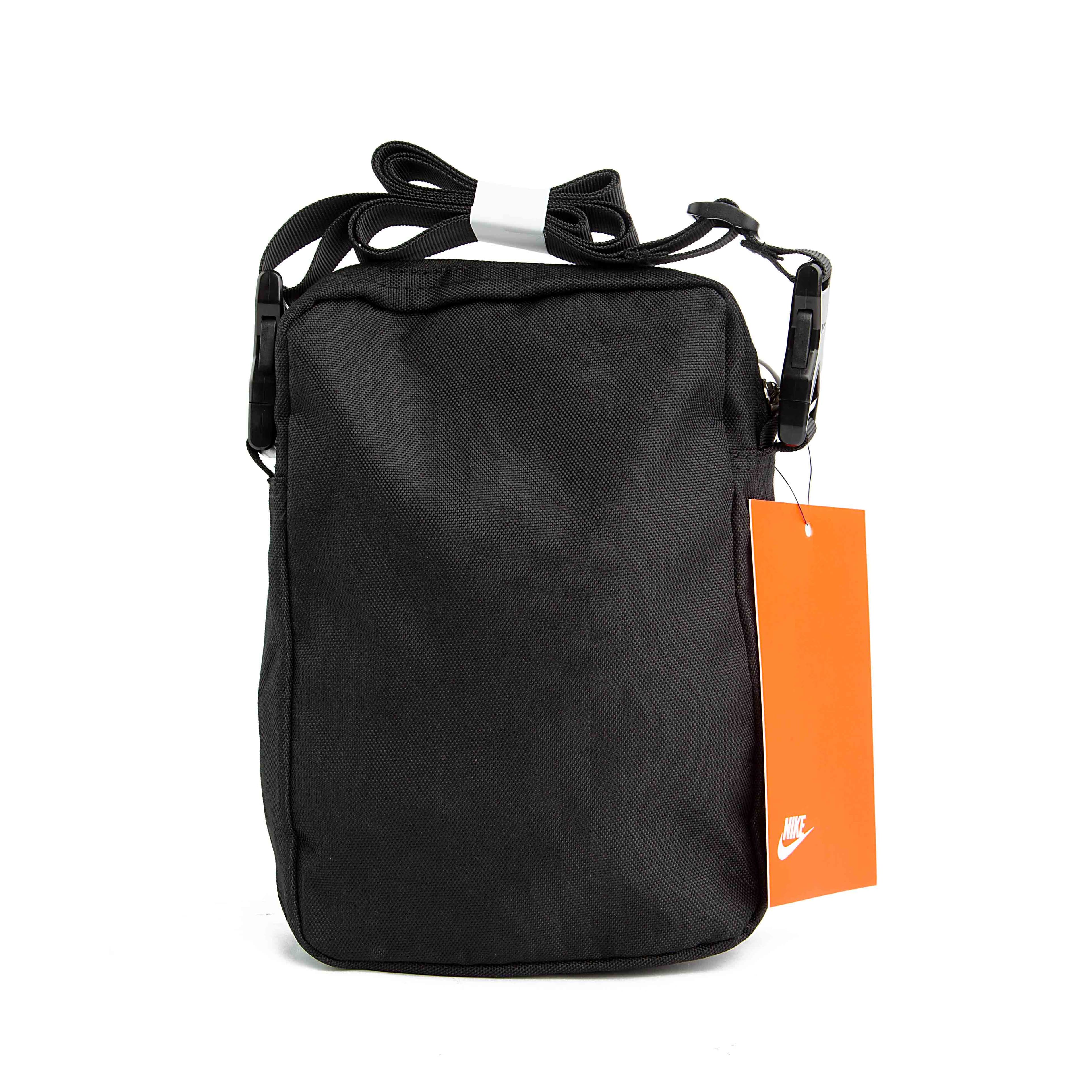 This is a compact, rectangular shoulder bag. The bag is made of a durable, textured black fabric and features an adjustable shoulder strap. 