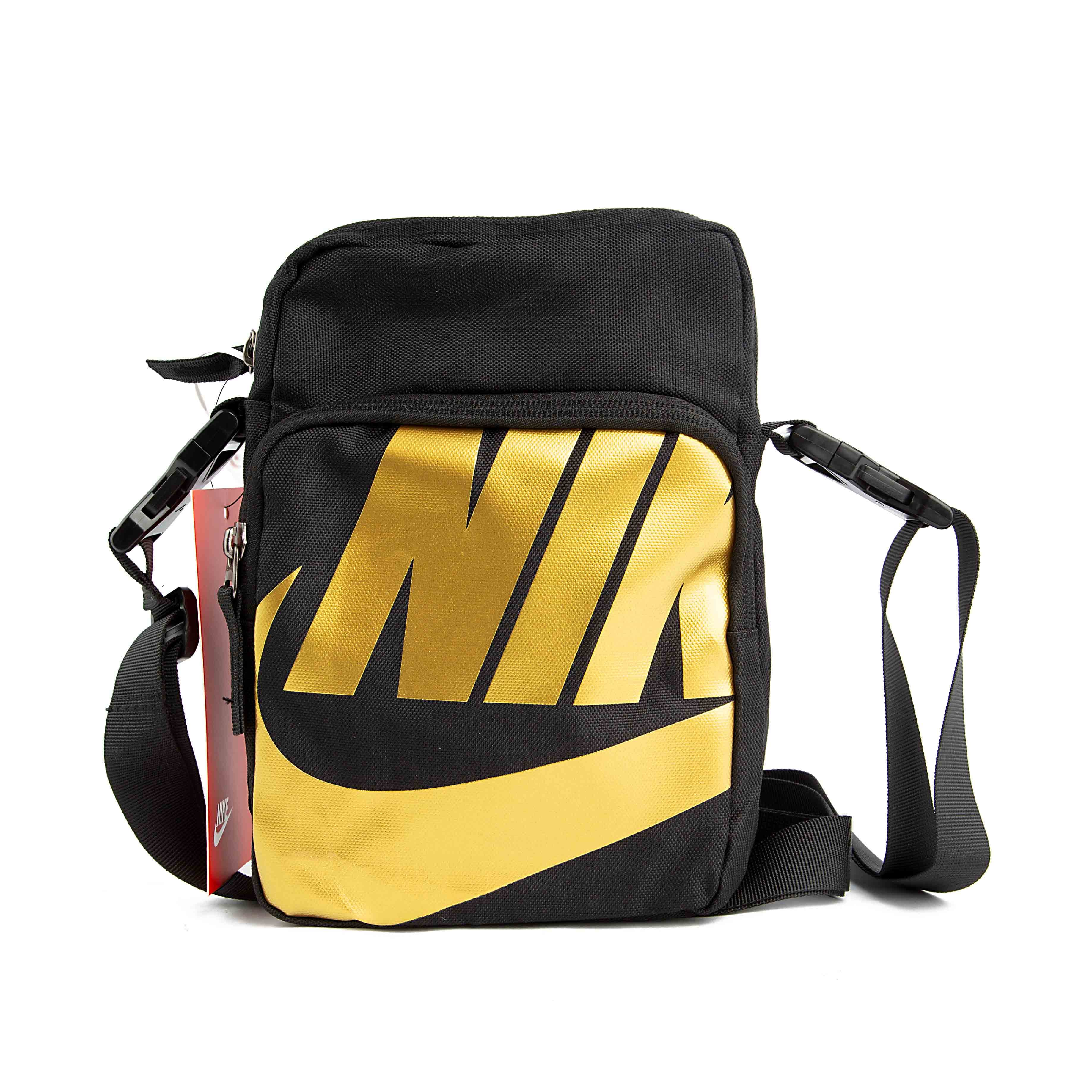 This is a compact, rectangular shoulder bag. The bag is made of a durable, textured black fabric and features an adjustable shoulder strap. 