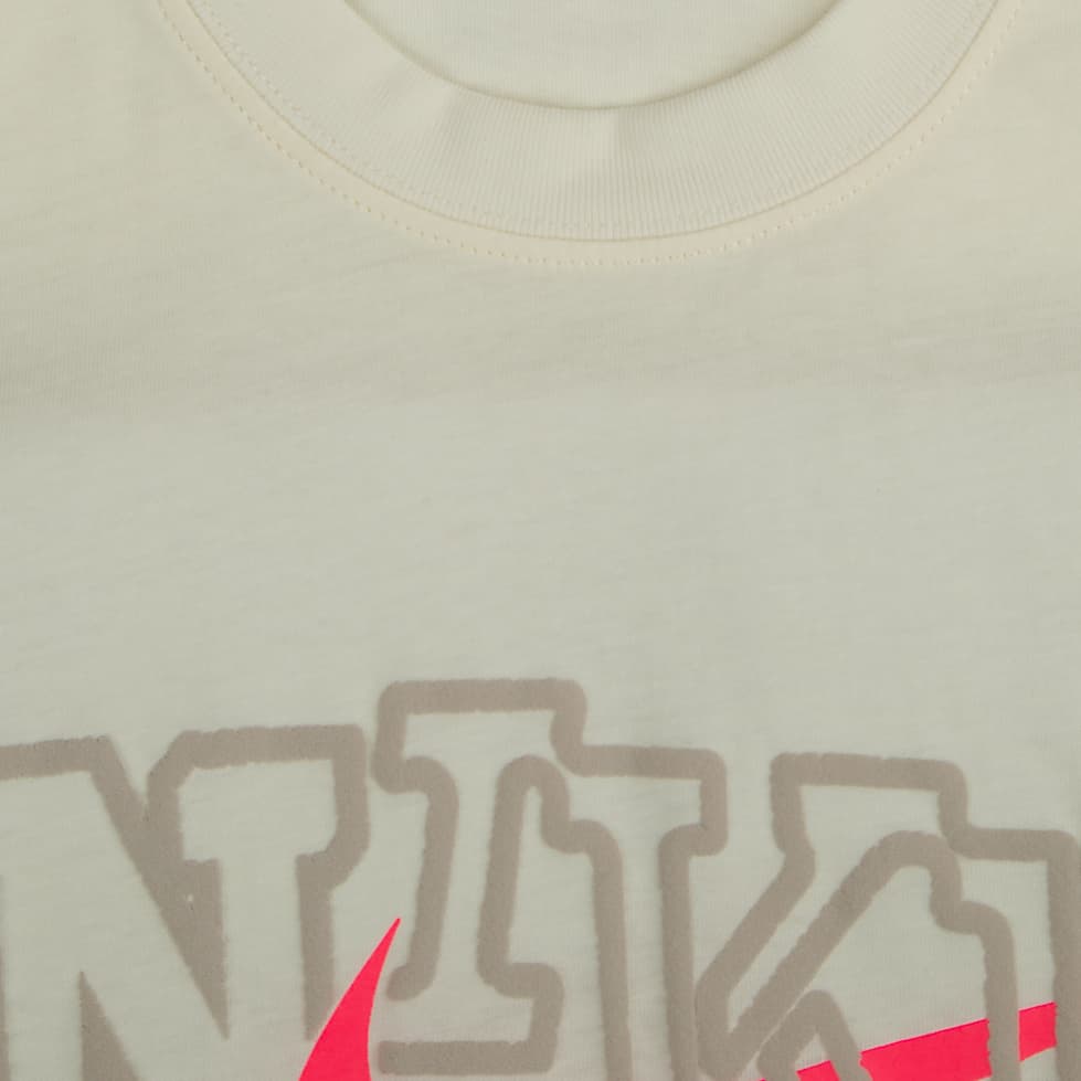 The Nike Tee" Graphic T-shirt. This tee offers a relaxed, stylish fit and features a unique graphic with a bold, contrasting Swoosh. It's a comfortable and eye-catching essential for everyday wear.