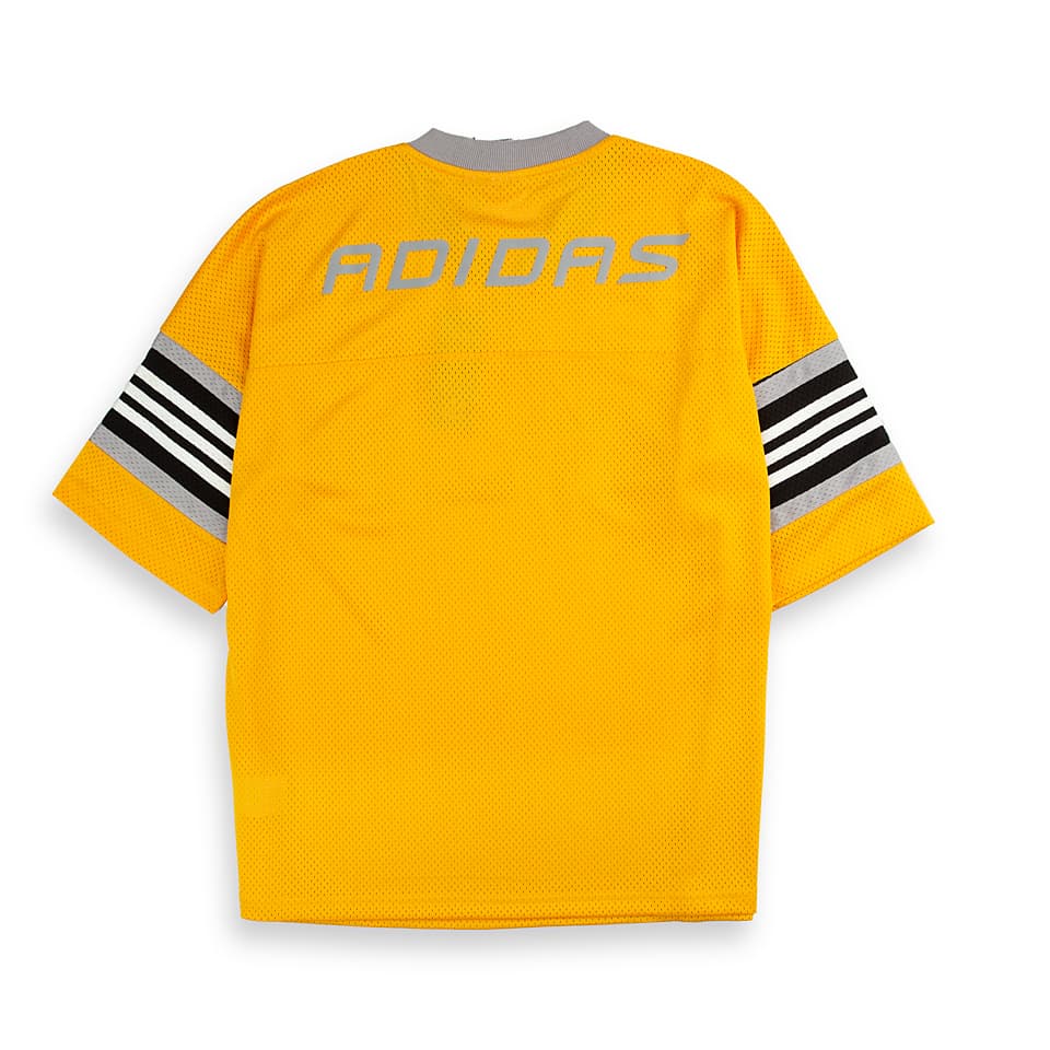 Adidas Originals mesh jersey. This unisex yellow jersey features a large "03" graphic, striped sleeves, and a lightweight feel for a sporty look