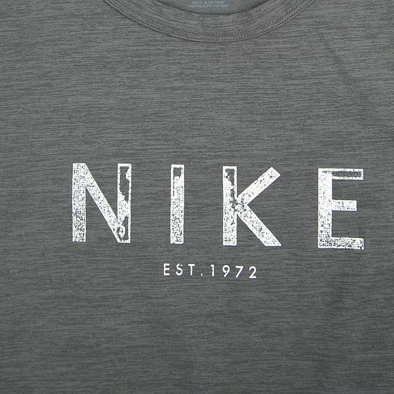 A heathered grey Nike Heritage T-shirt with a distressed white "NIKE" and "EST. 1972" logo on the chest.