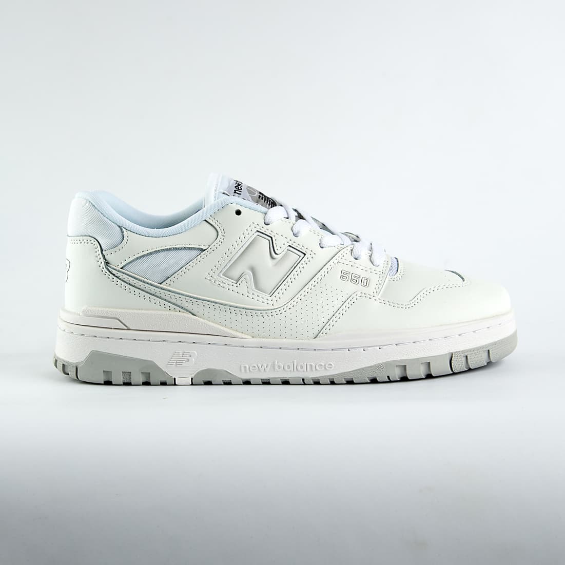 New Balance 550 sneakers in an off-white and light gray colorway. A classic low-top style with a minimalist look for men and women.