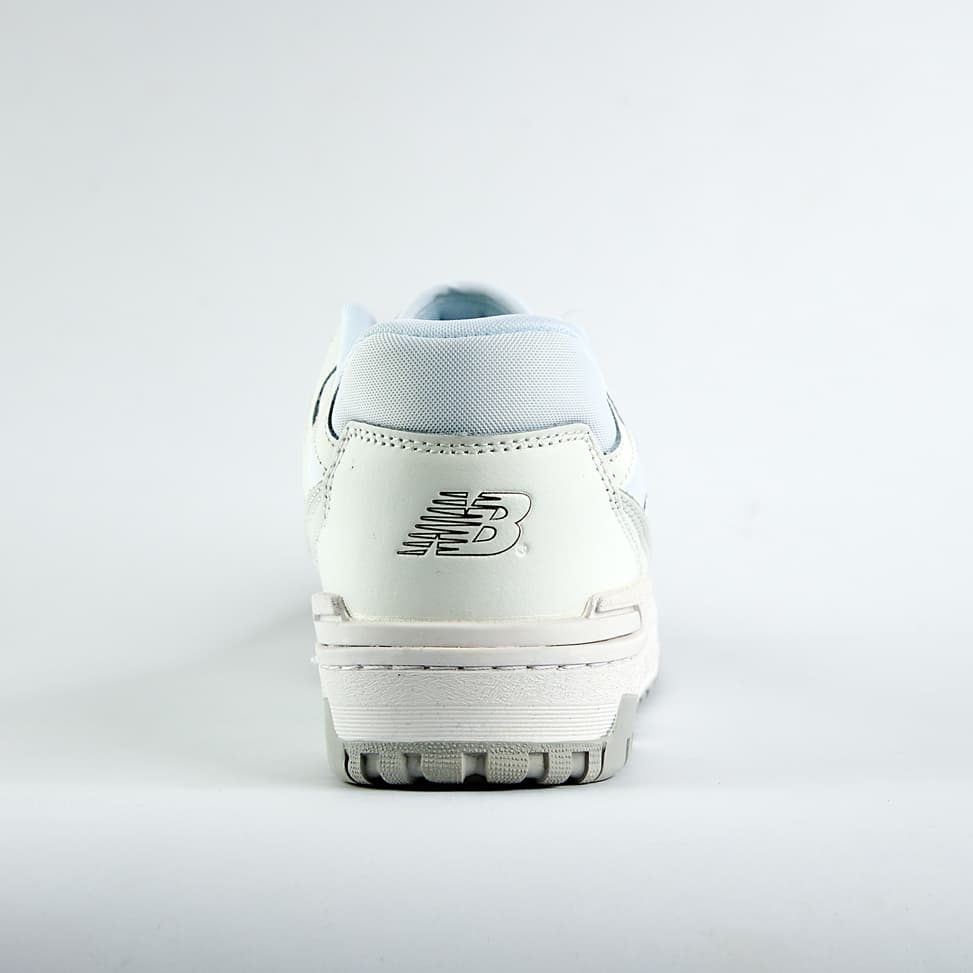    New Balance 550 sneakers in an off-white and light gray colorway. A classic low-top style with a minimalist look for men and women.