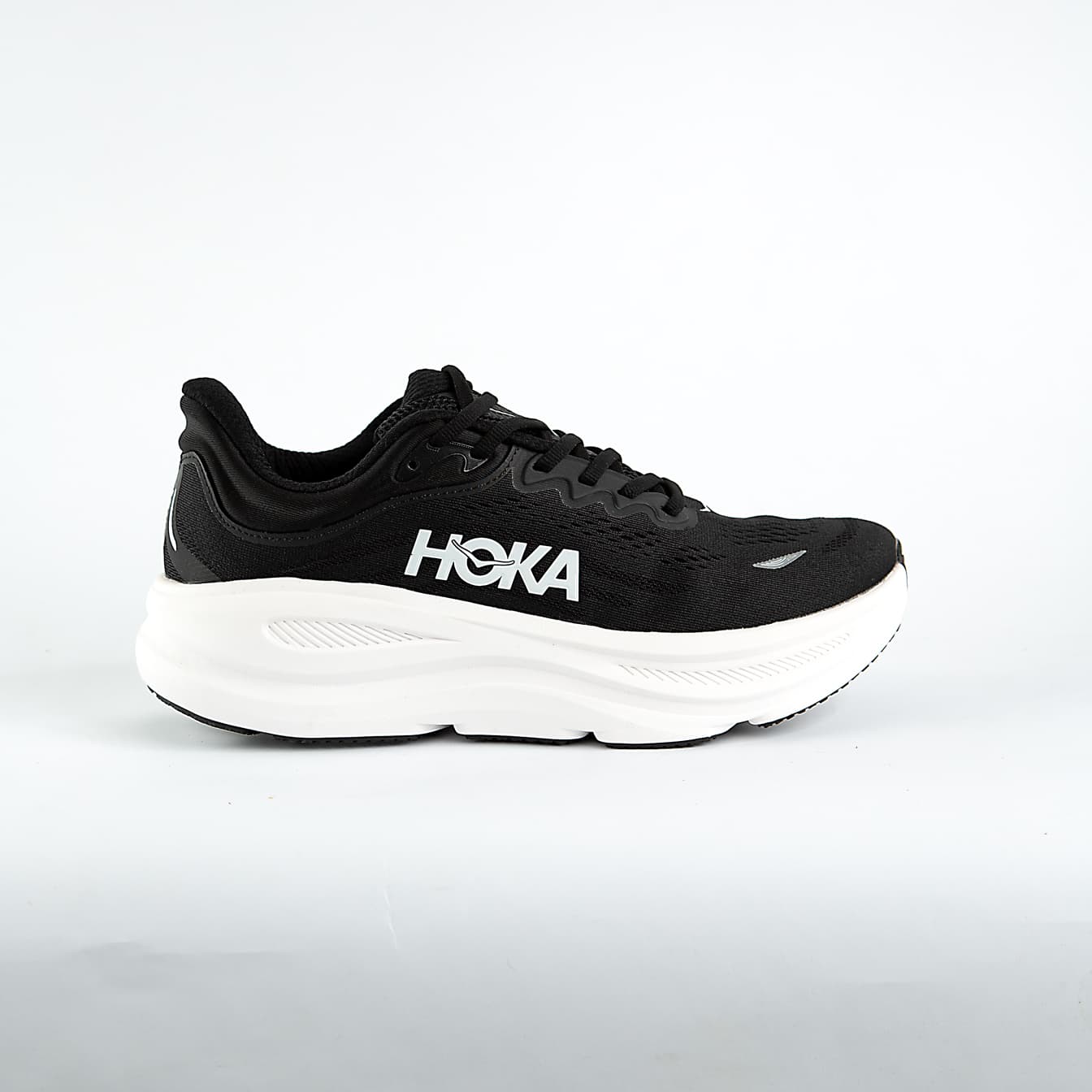 A pair of black and white Hoka Bondi 9 Sneakers cushioned road running shoes, known for maximum comfort and support for everyday runs and walks.