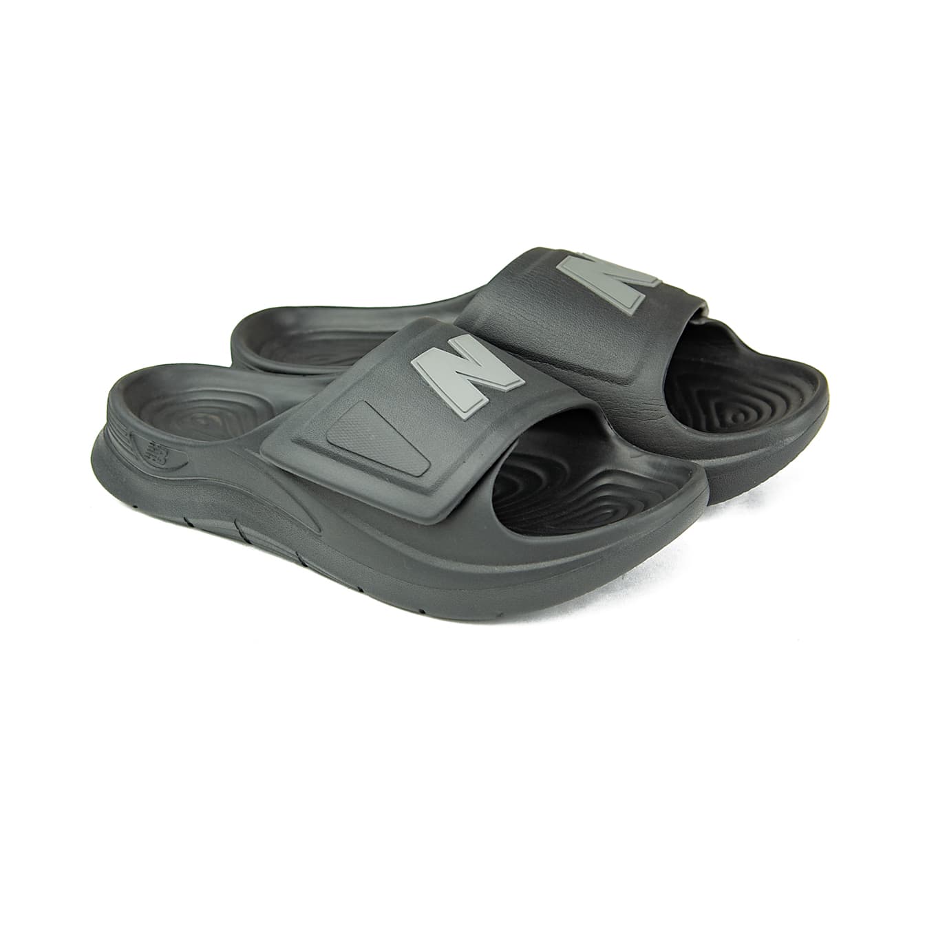 A pair of black New Balance 202XA adjustable slide sandals with a grey NB logo on the strap, shown against a white background.