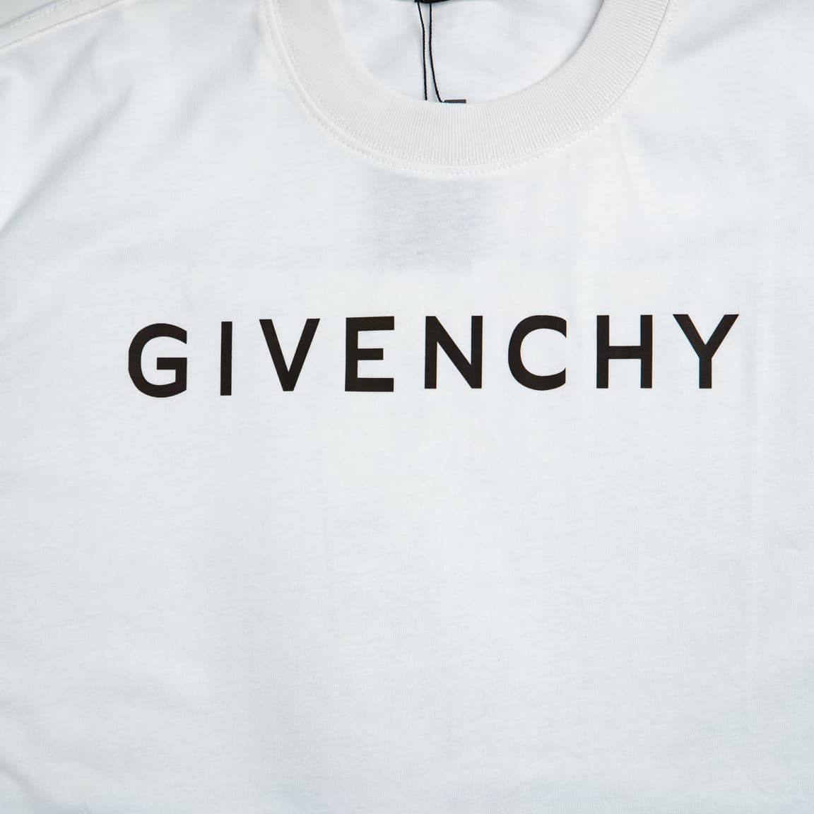 White Givenchy unisex cotton T-shirt with a central black block-letter logo print.