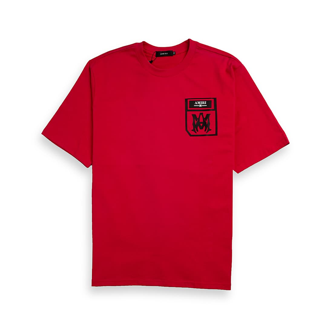 Red Amiri unisex t-shirt with a black printed pocket logo featuring the AMIRI text and M monogram on the chest.
