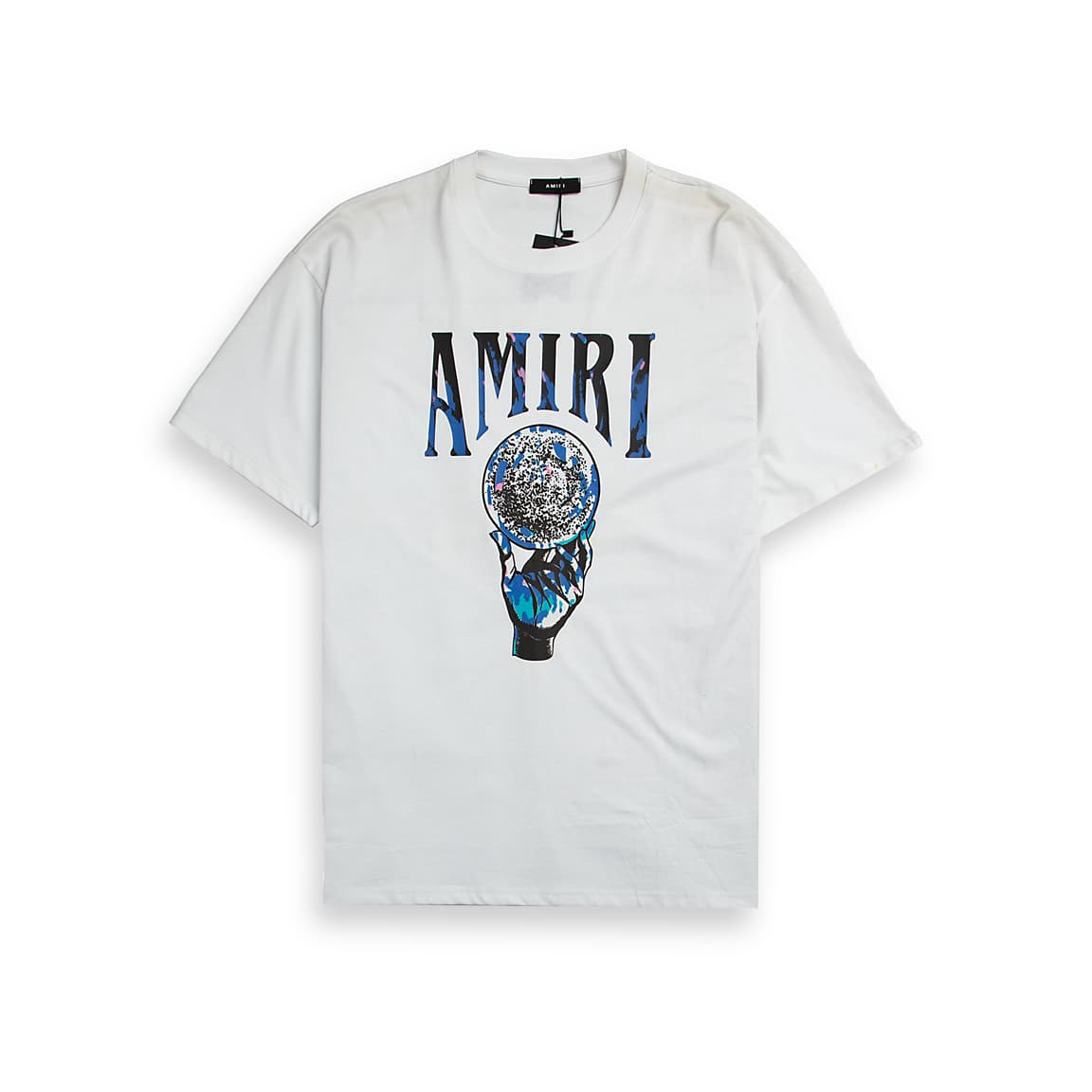 White Amiri unisex t-shirt with a central graphic featuring the AMIRI logo and a hand holding a crystal ball/globe.