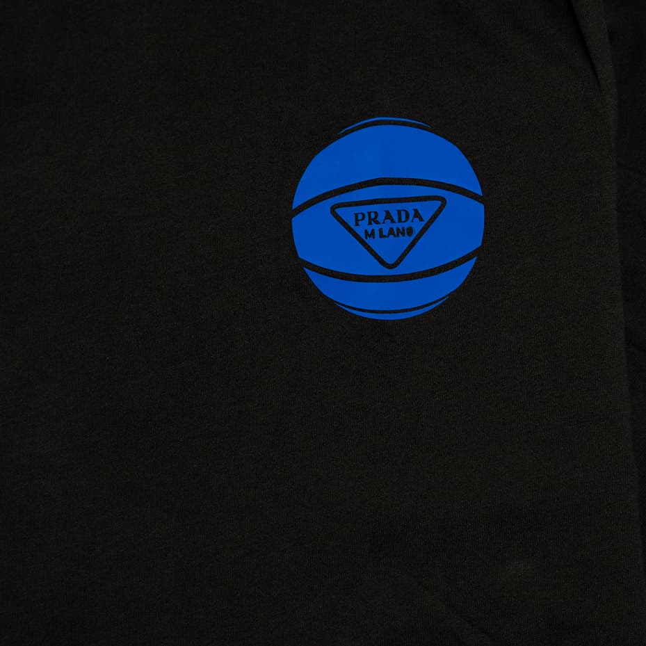 Black t-shirt with small royal blue circular "all-seeing eye" logo on the chest, unisex, crew neck.