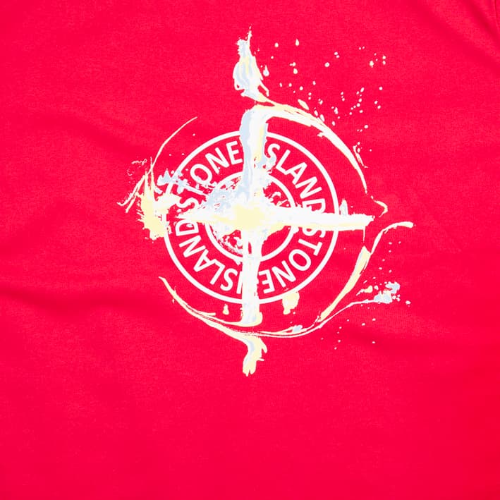 Scarlet red Stone Island t-shirt with distressed Compass logo graphic on chest, short sleeves, designer casual wear.